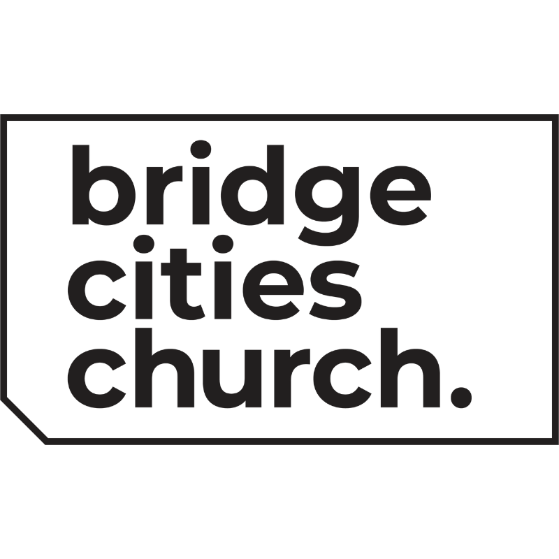 A black sign with the text "bridge citys church." in bold, lowercase letters.