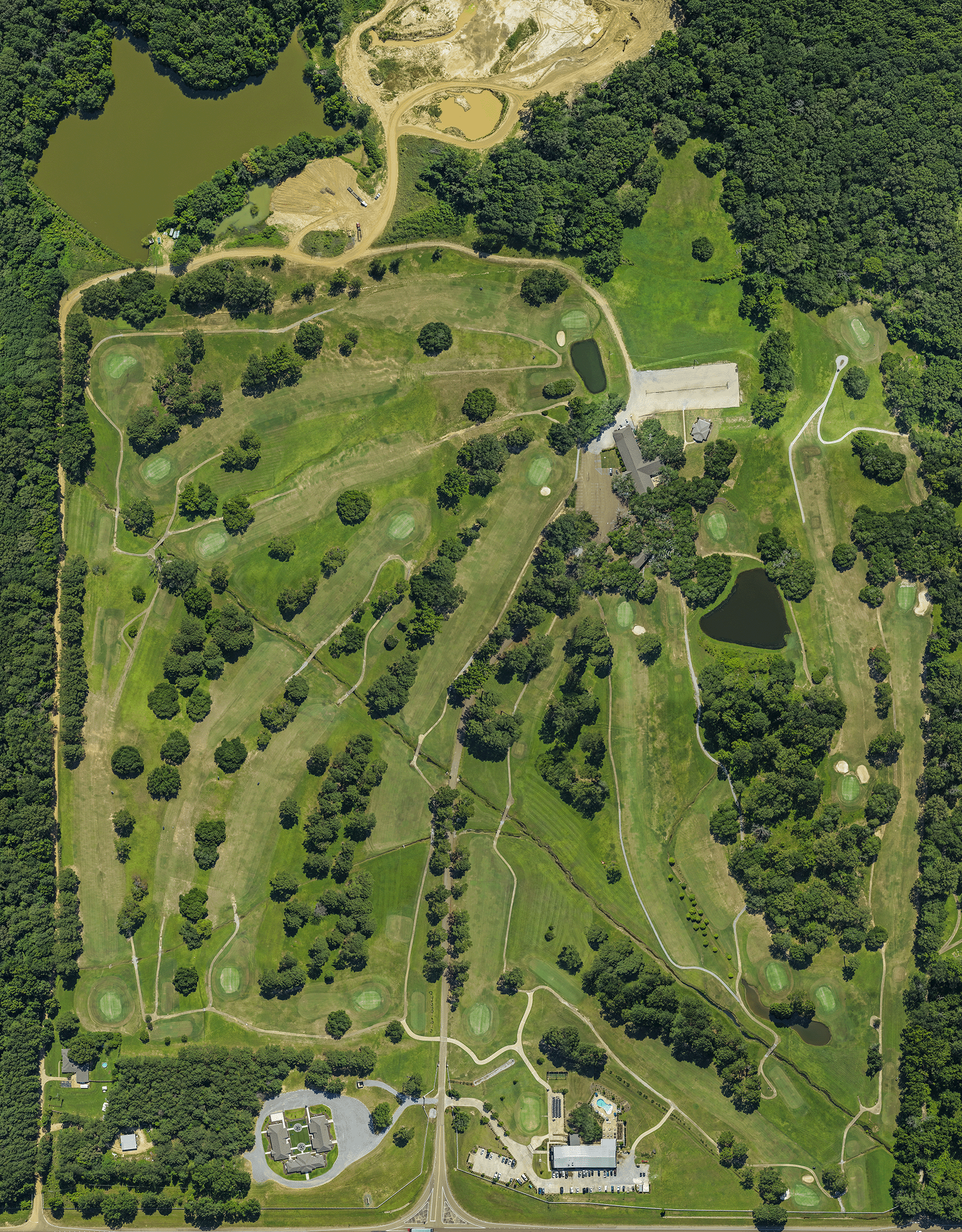 Aerial view of Live Oaks Golf Club course in Jackson, Mississippi, showing tree-lined fairways, manicured greens, ponds, and clubhouse facilities