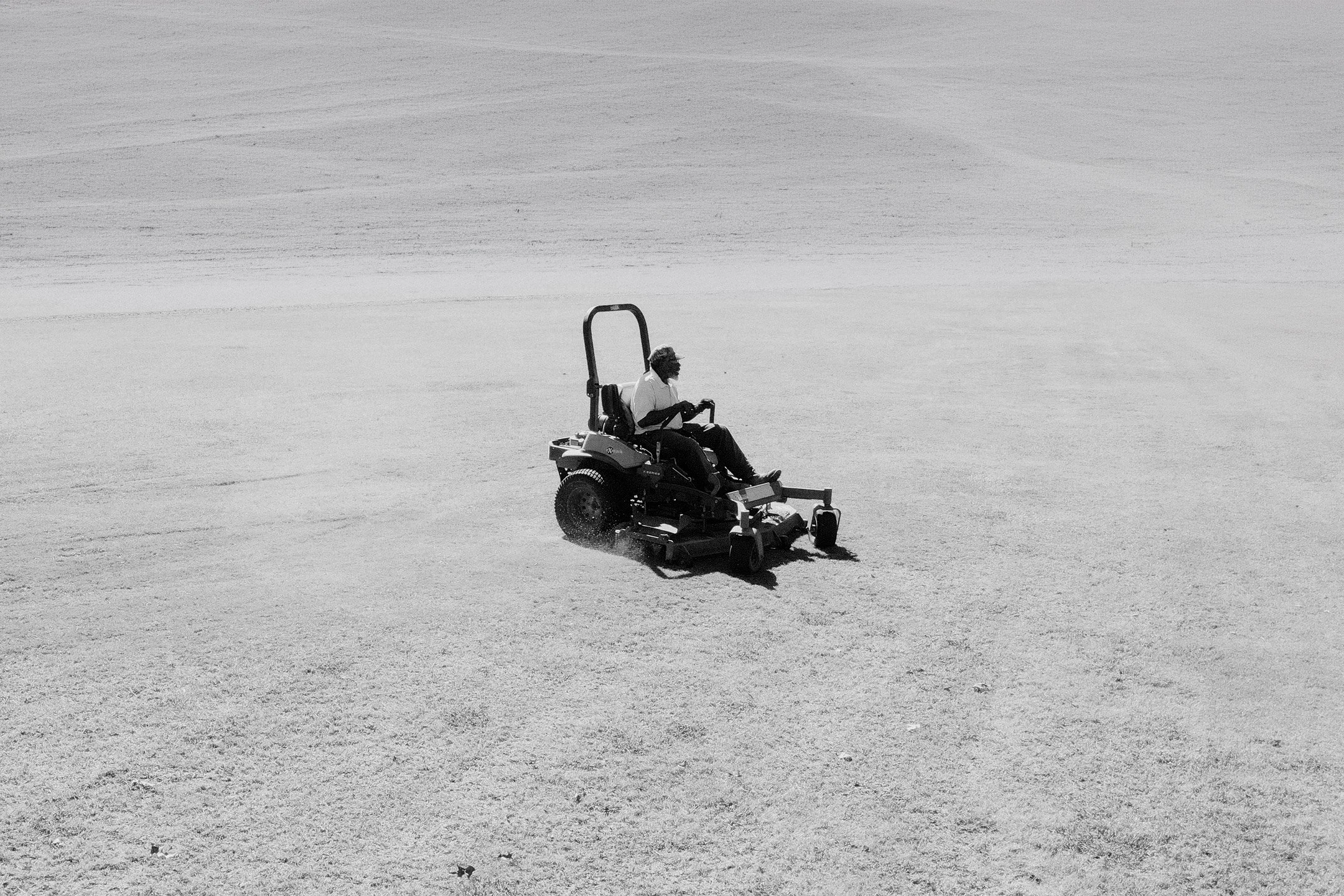 A grounds crew member mowing the fairway on a commercial zero-turn mower at Live Oaks Golf Club in Jackson, Mississippi, showcasing the course's commitment to well-maintained playing conditions and professional turf management.