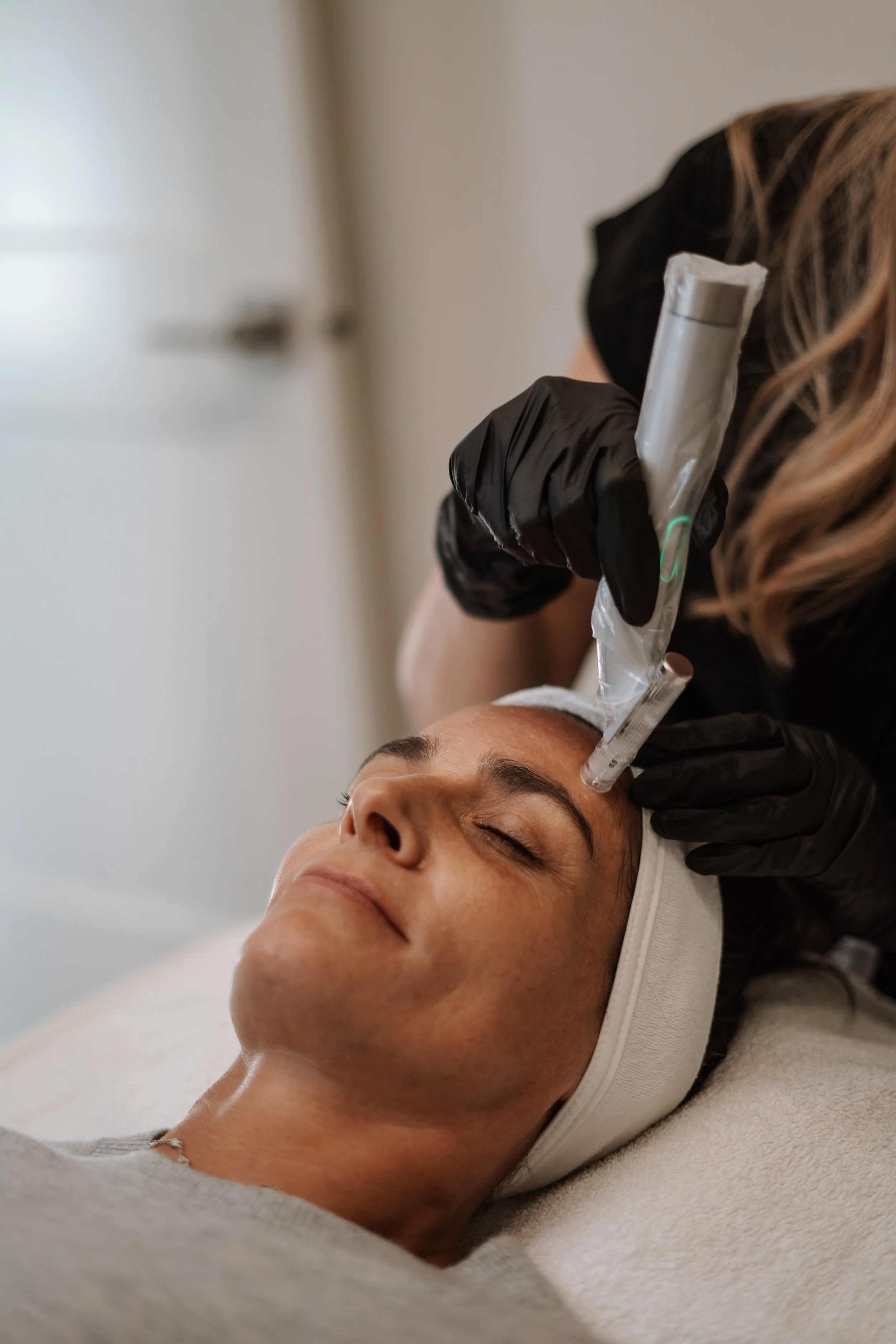 Client receiving EvoPen microneedling treatment at Nude Skin & Laser in Langley, BC to stimulate collagen, improve skin texture, and support skin rejuvenation.