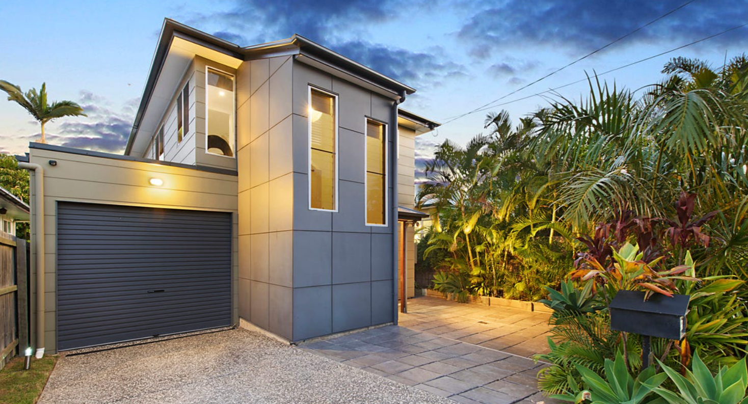 Contemporary home facade with garage, clean lines and landscaped entry
