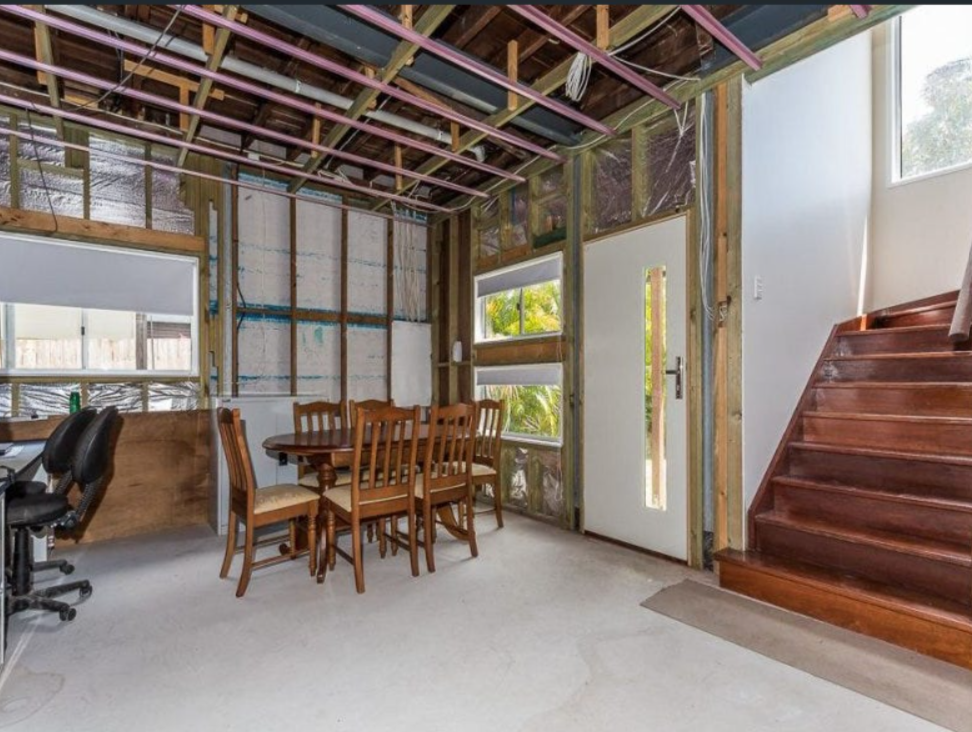 Unfinished interior space with exposed ceiling beams and timber framing