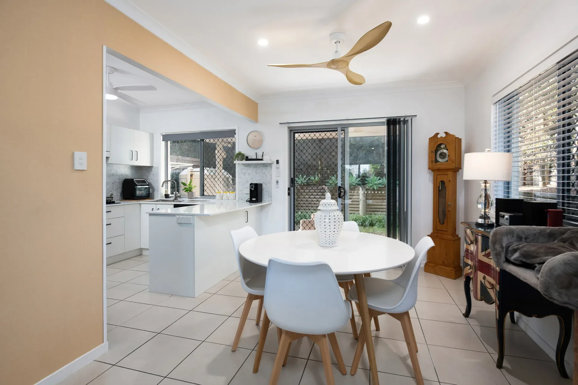 Interior designed dining space with a white round table and four chairs