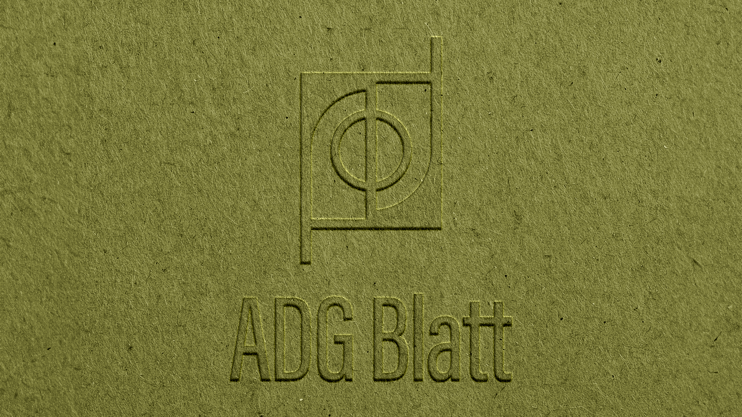Embossed logo with a flower and circle design above the text "ADG Blatt" on a textured green surface.