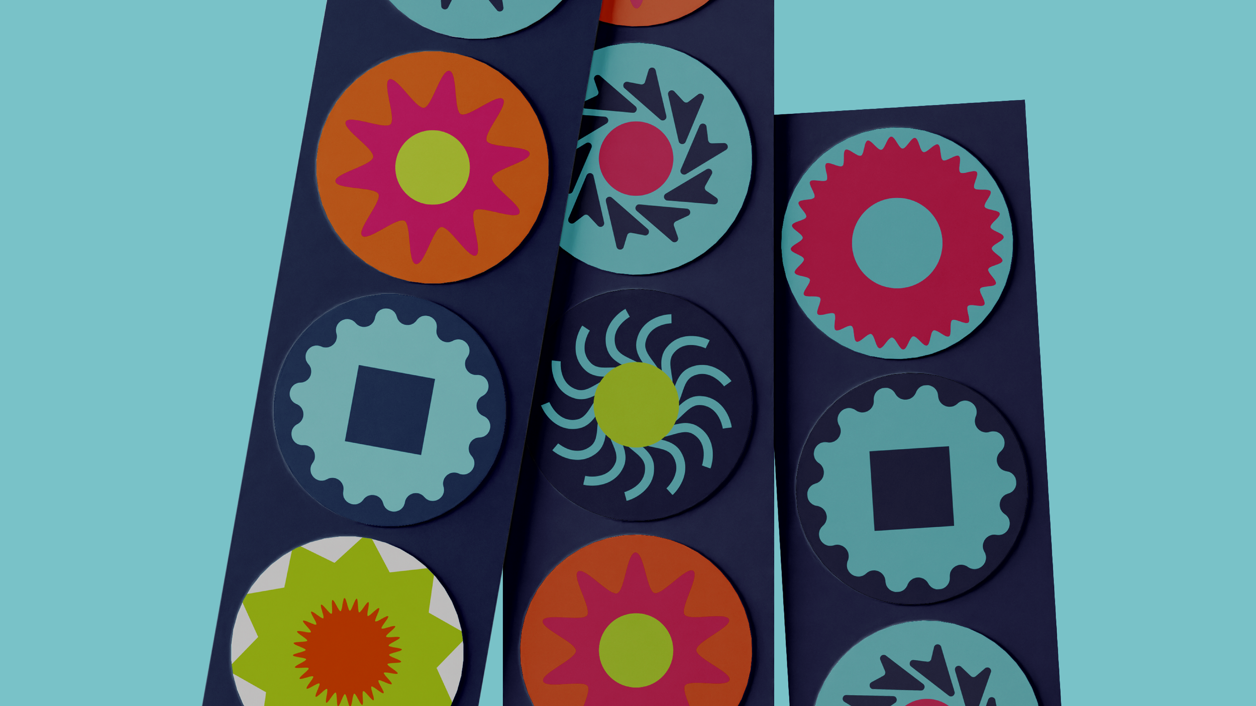 Colorful geometric round patterns on dark blue and light blue backgrounds, arranged in vertical strips.