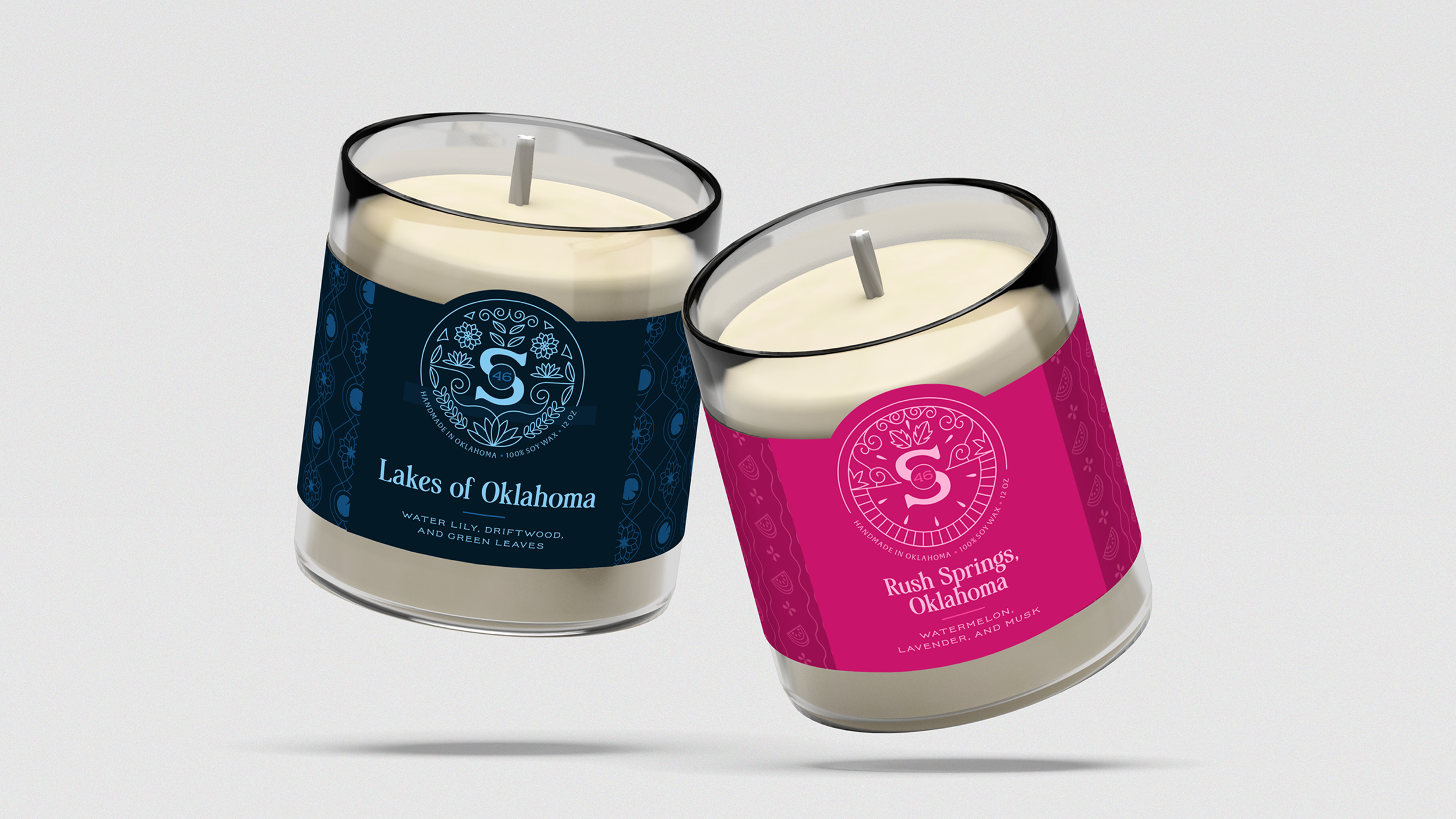 Two scented candles in glass jars with black rims, labeled 'Lakes of Oklahoma' and 'Rush Springs, Oklahoma'