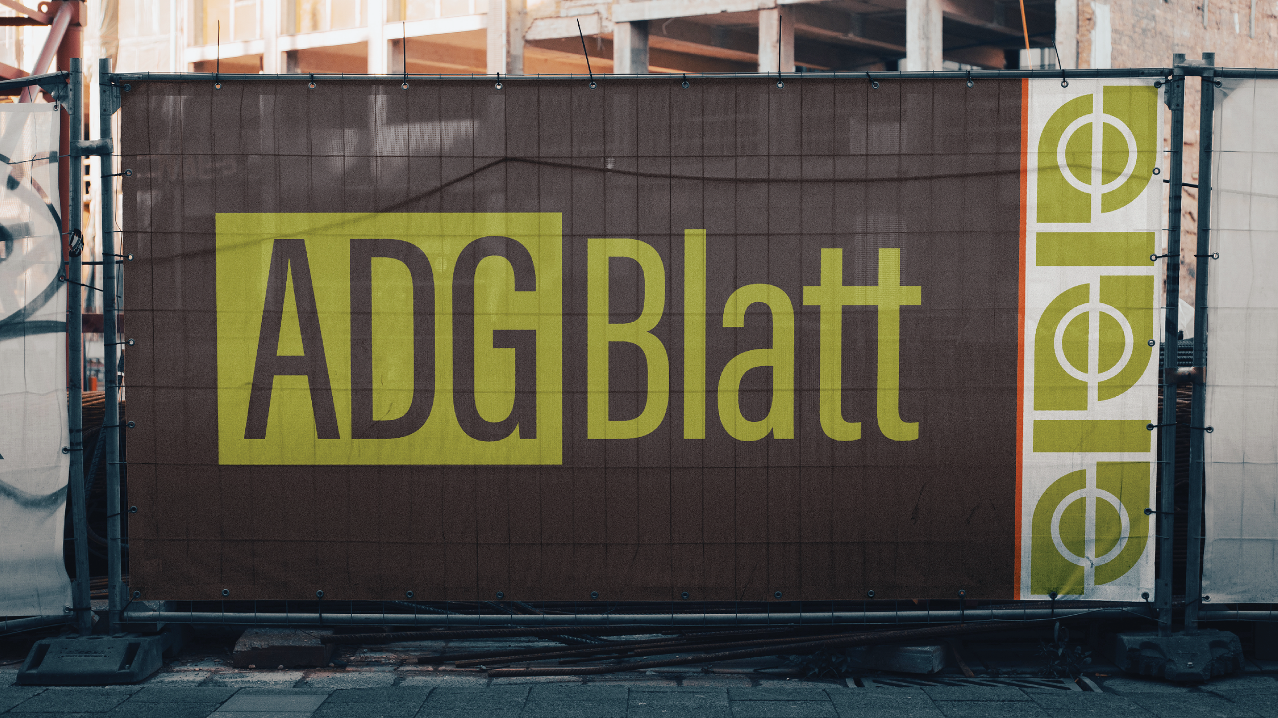 Outdoor billboard with the text 'ADGBatt' in large letters, background in brown, with a green border on the right featuring white and green symbols resembling basketballs.