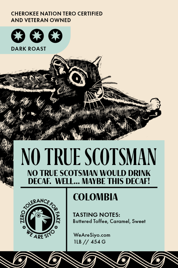 Label for dark roast coffee beans from Colombia featuring a cat holding a slice of toast, with text indicating certification as Cherokee Nation Tero Certified and veteran owned, and slogans about no true Scotsman and decaffeinated coffee, along with tasting notes of buttered toffee, caramel, and sweet.