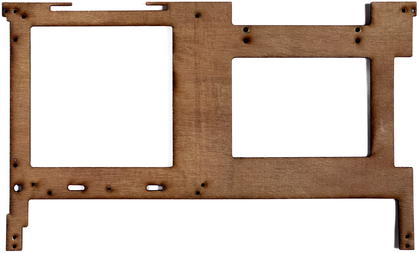 A wooden frame or panel with multiple cutouts and holes, likely a component of machinery or equipment.