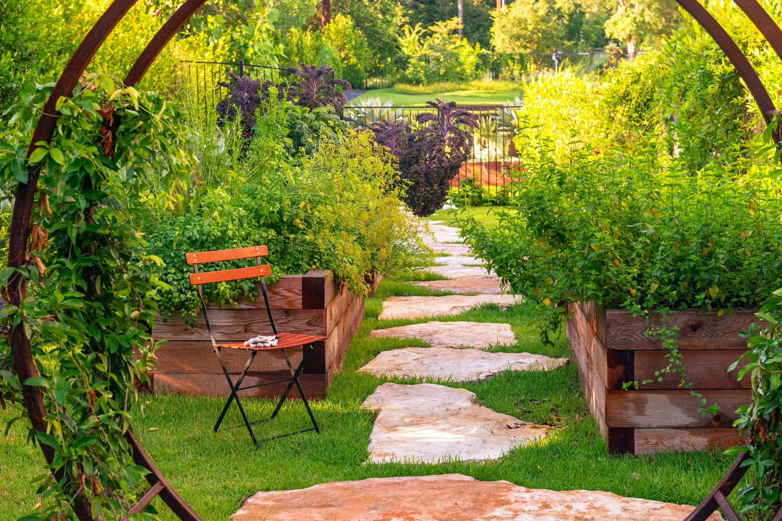 A custom steel moon gate creates a welcoming entry to the new vegetable garden.