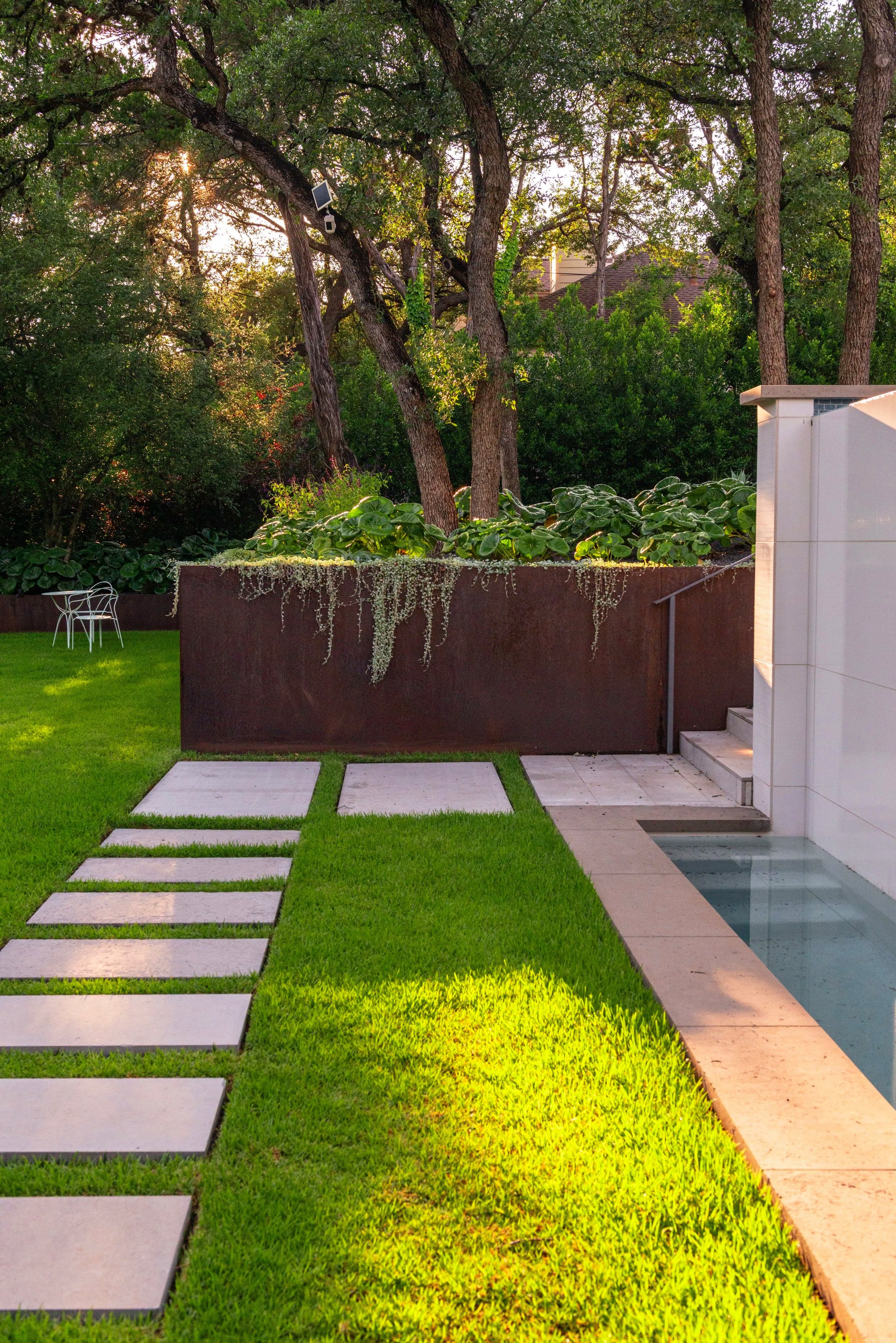 Stately steel planters create striking focal points, anchoring key views while forming a series of sculptural terraces throughout the landscape.