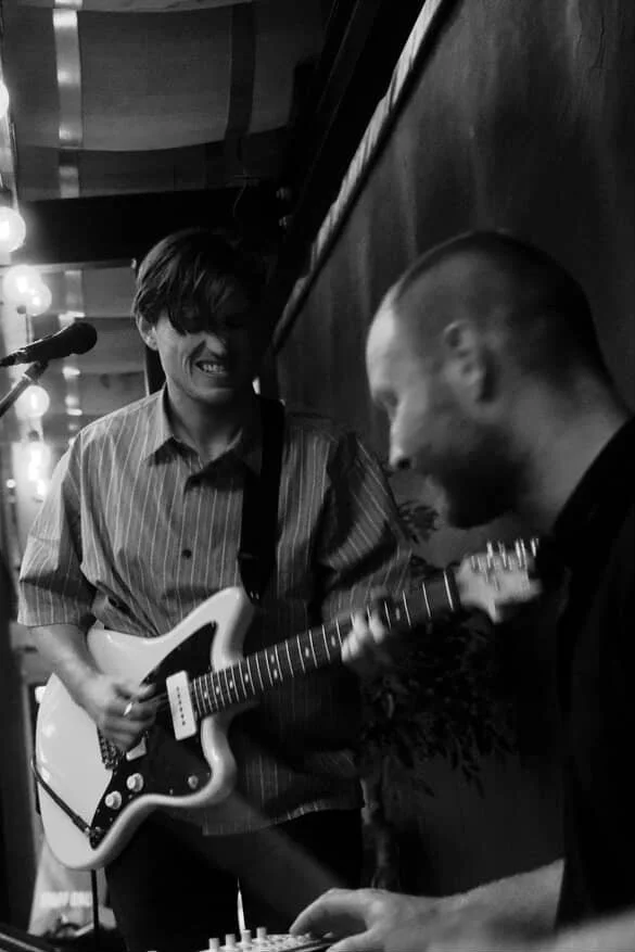 Slowverb wedding duo performing live, featuring electric guitar and synth in an intimate, atmospheric setting.