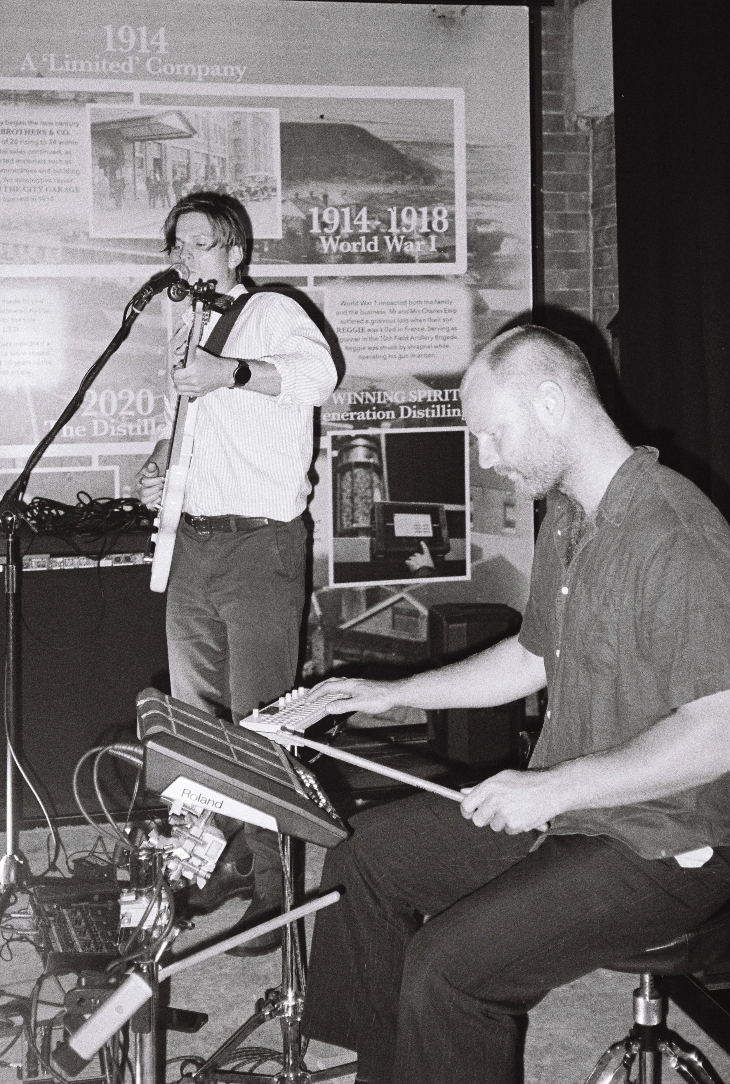 Slowverb wedding duo performing live with electric guitar and electronic percussion in an intimate indoor setting.