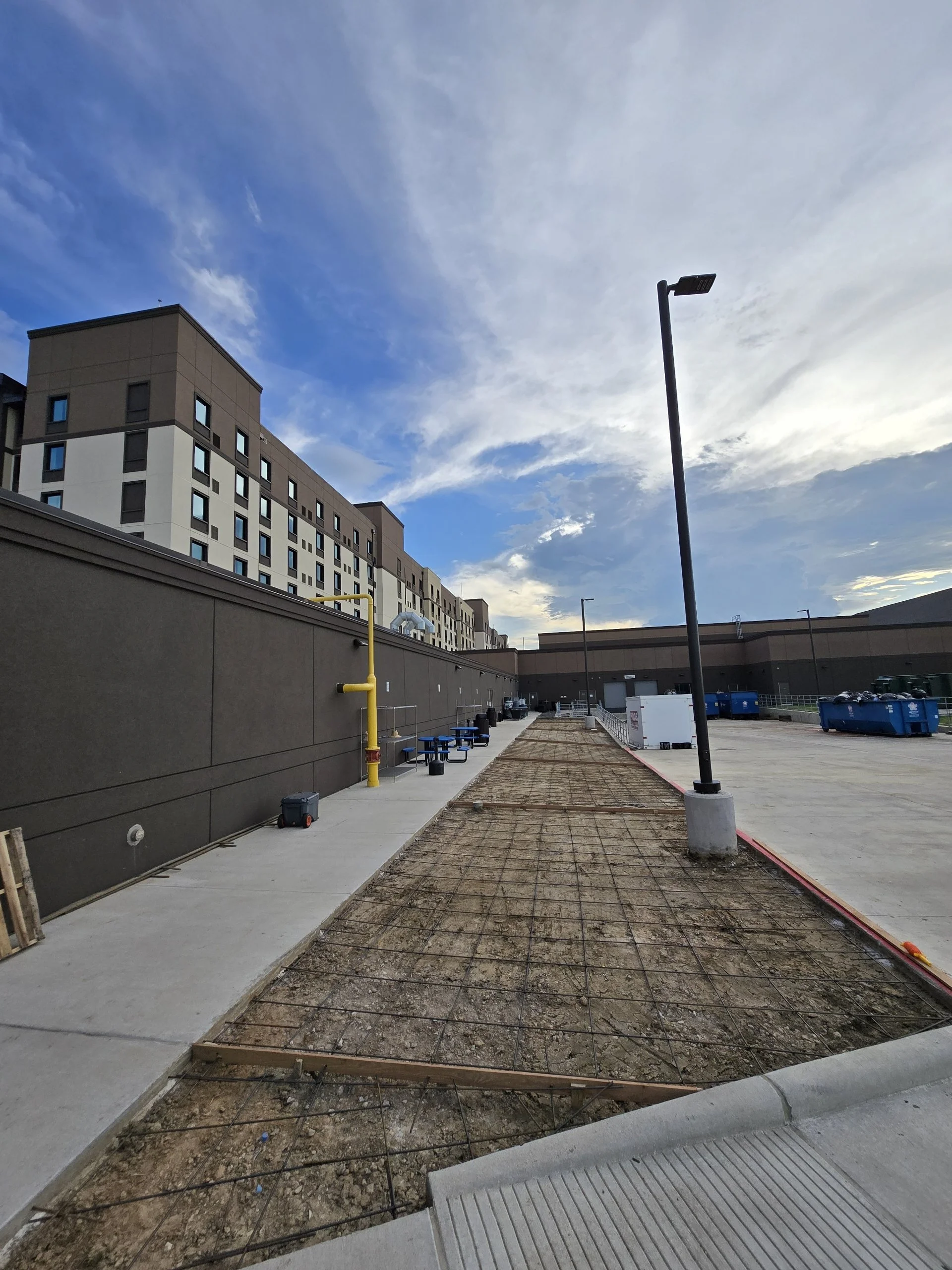 The foundation is carefully prepared with reinforced rebar, ensuring a strong, durable, and long-lasting sidewalk before the concrete is poured.