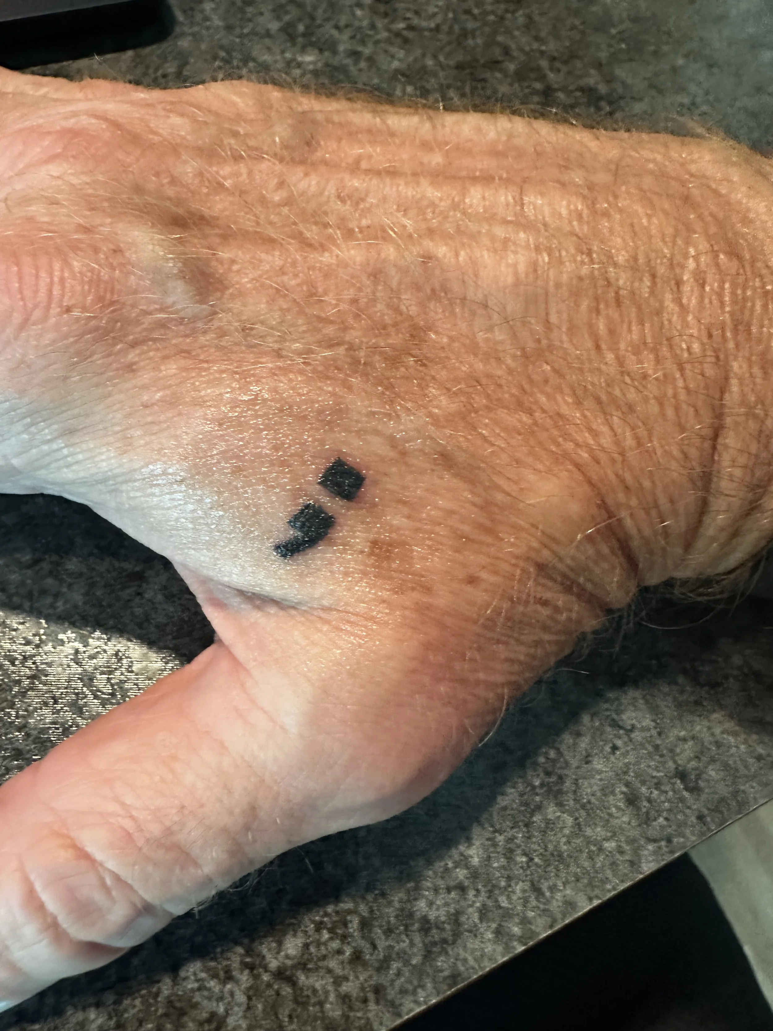 A semicolon tattoo