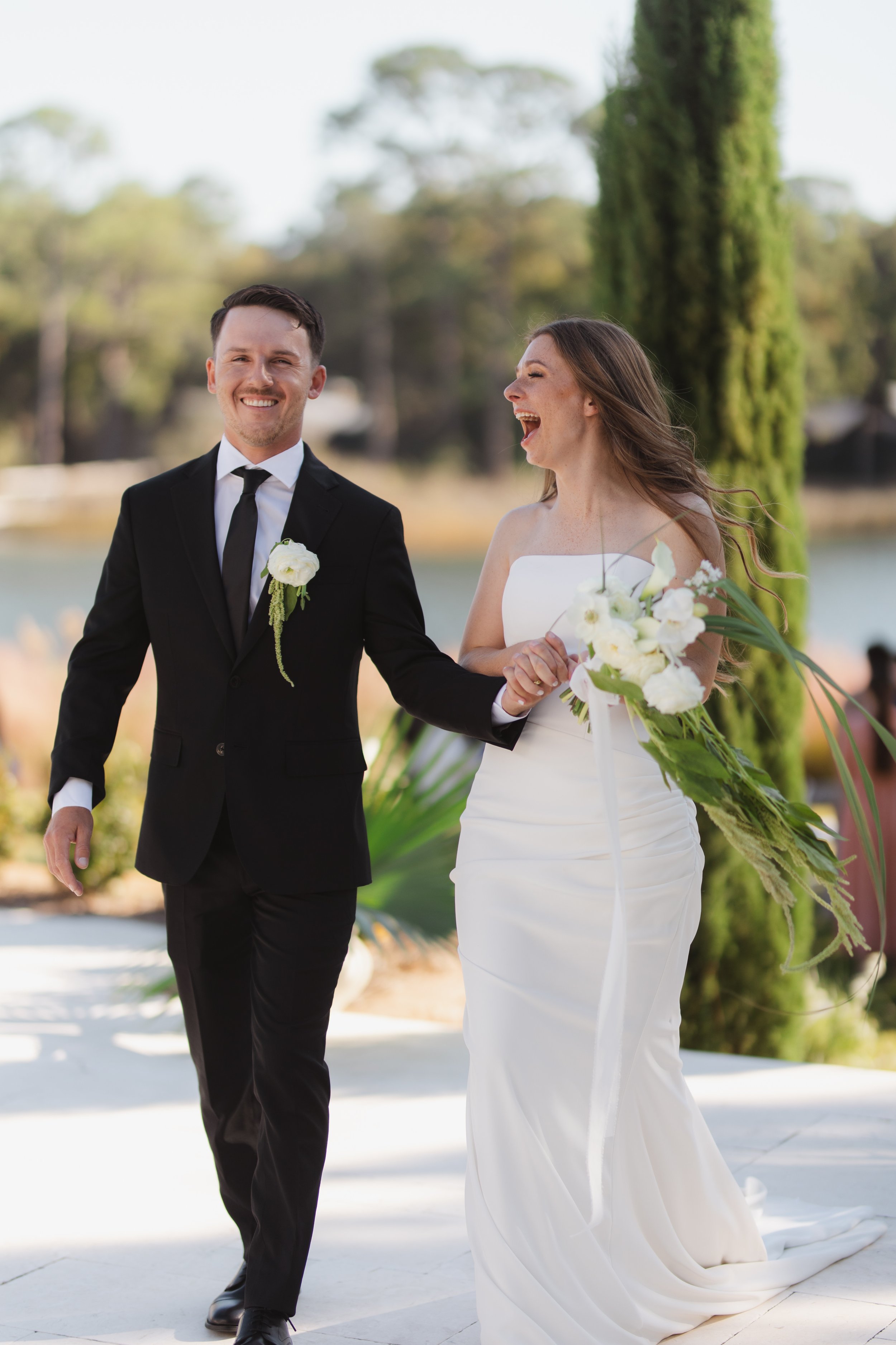 Laurie’s customers, Fernando and Kate embracing by the lake on their wedding day.
