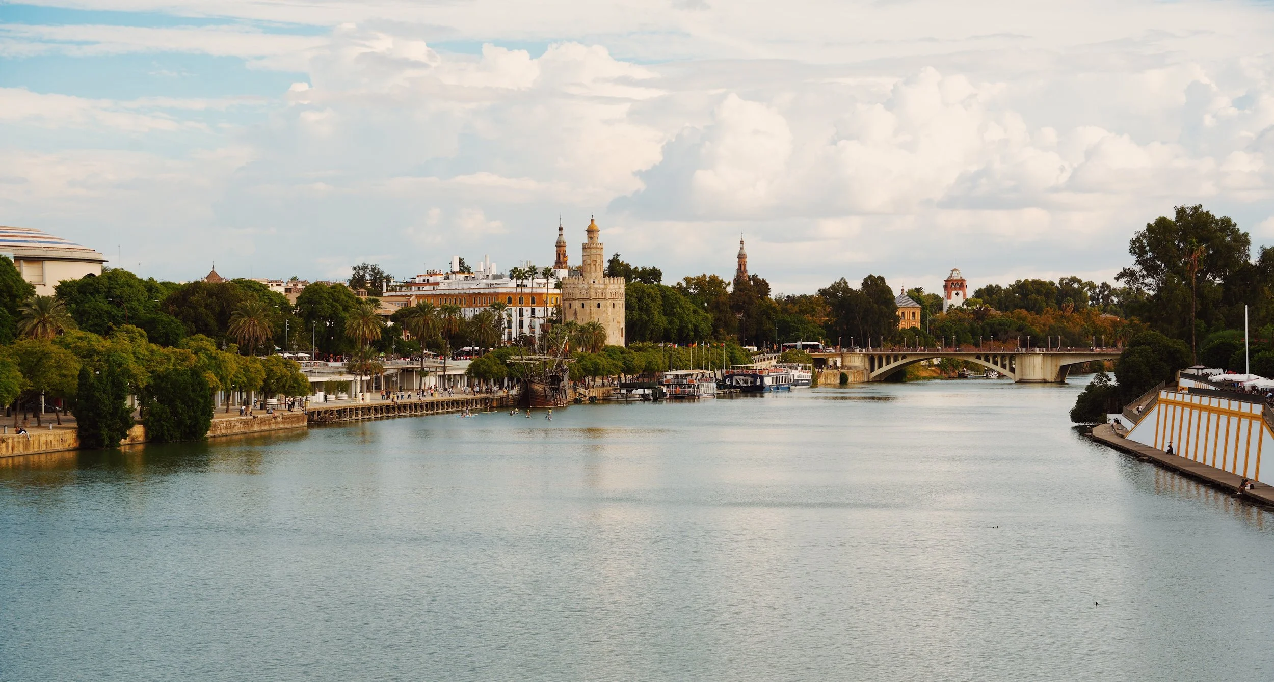 views of the river from the isabell II bridge in seville, spain- good to know for travelers heading to seville