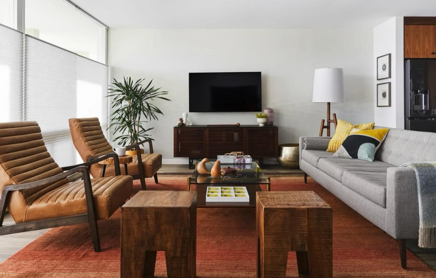 In this living space, layered warm woods, tailored upholstery, and a grounded palette create a room that feels both elevated and deeply livable. Every piece was selected to balance comfort with structure, texture with calm, and style with longevity. 