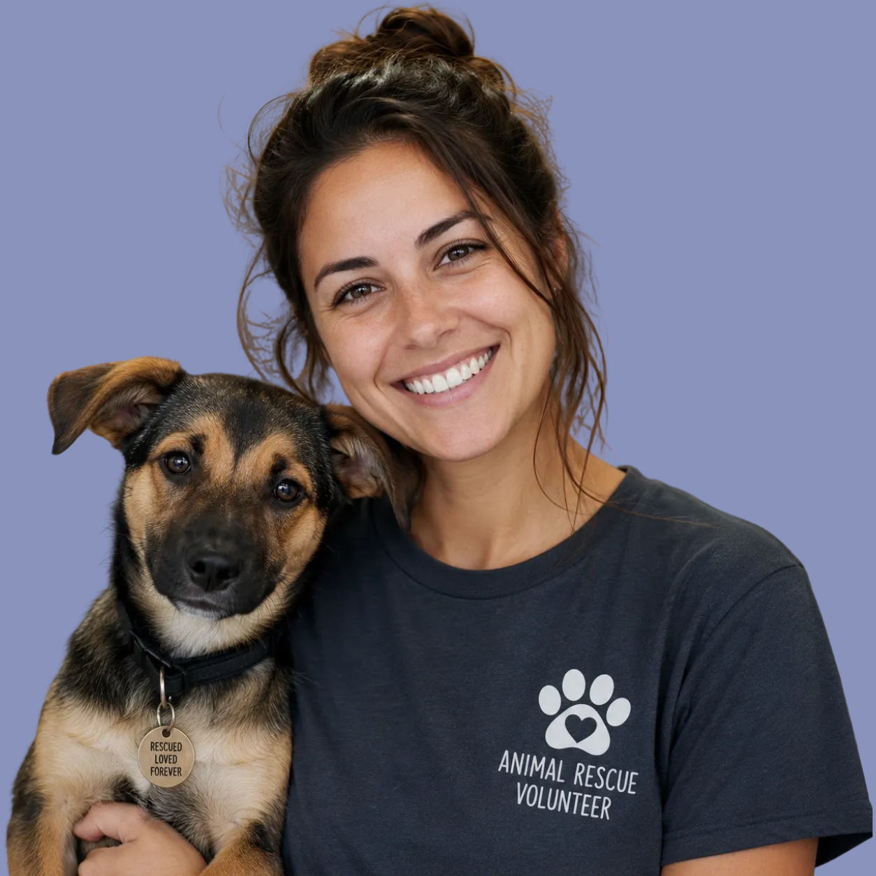 A smiling woman holding a dog with a rescue-themed tag and wearing a shirt that says 'Animal Rescue Volunteer' against a purple background.