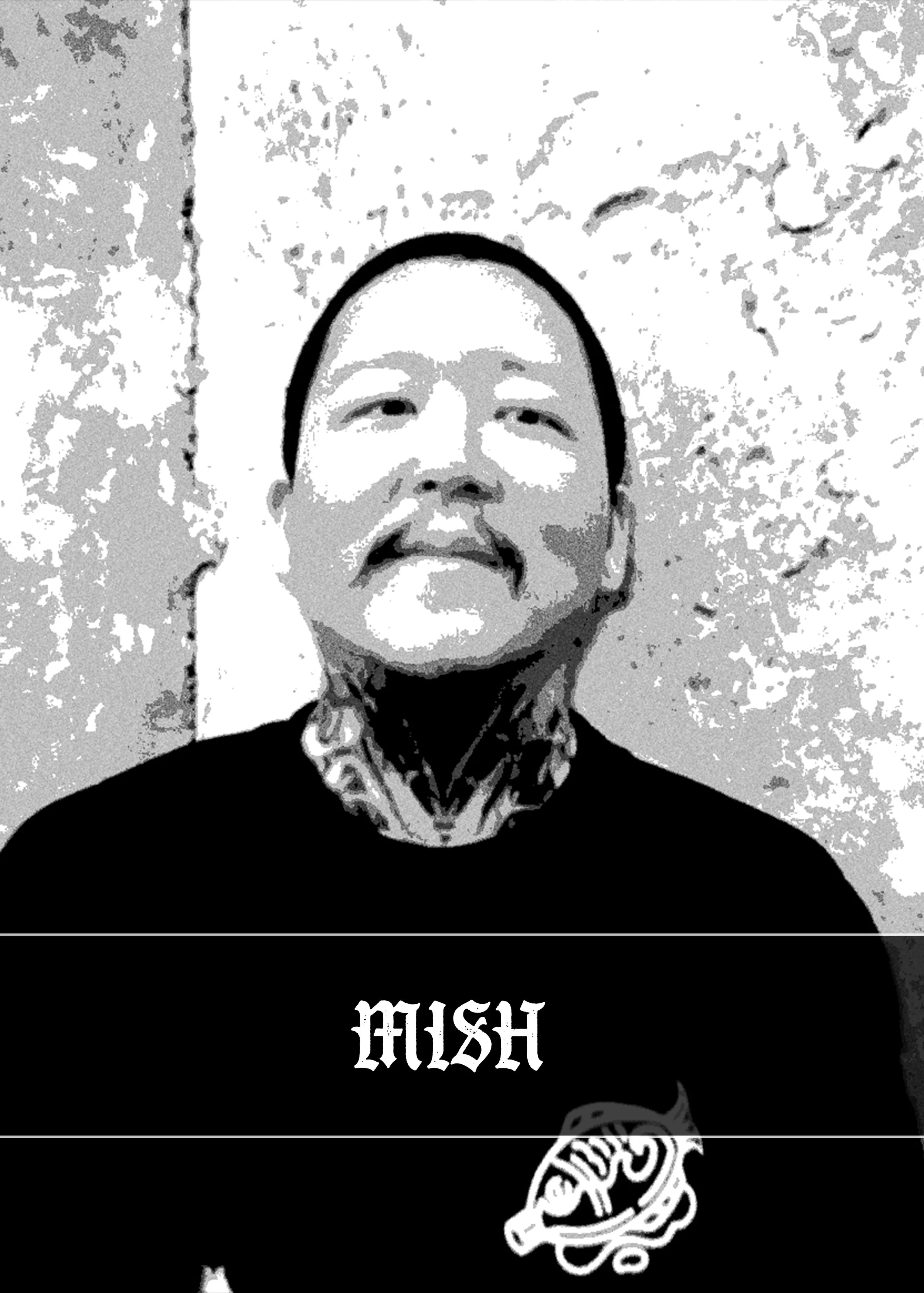 A person with facial tattoos wearing a beanie and a black shirt with 'MISH' written on it, inside a room with textured walls.