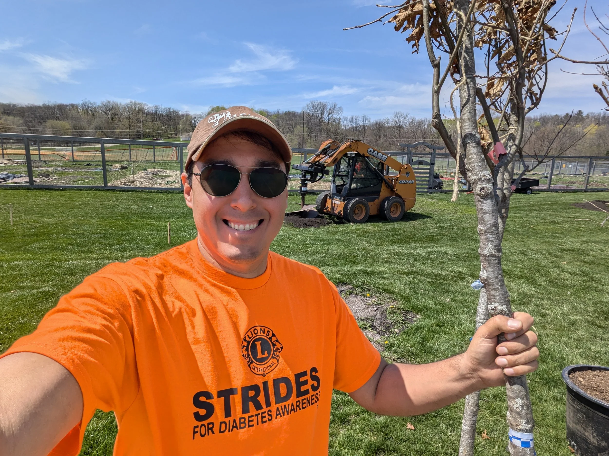Adam working as a Tree Enhancement Committee member and Lions Club volunteer, helps to replace trees lost to the 2024 tornado