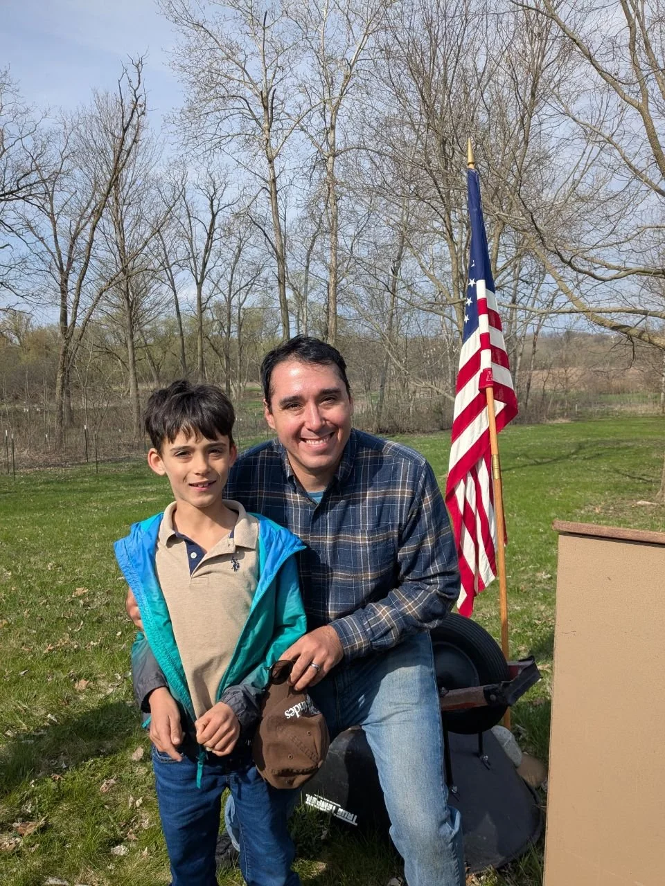 Adam poses with his son after giving the 2025 Arbor Day Proclamation at Kishwauketoe