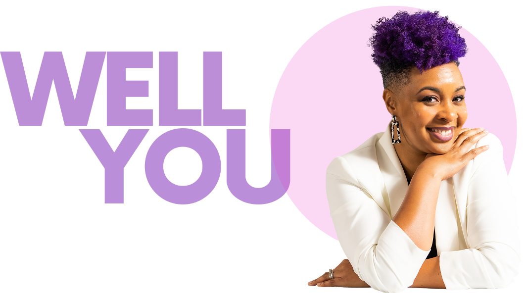 A smiling woman with purple curly hair, wearing a white blazer, resting her chin on her hand, in front of a pink background with purple text saying 'LOVE YOU'.