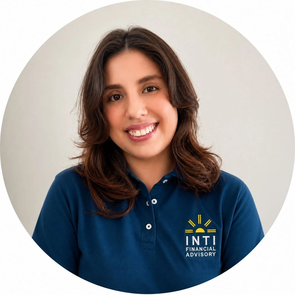 A young woman with shoulder-length wavy brown hair smiling, wearing a navy blue collared shirt with a logo reading 'INTI Financial Advisory' on it, against a plain light background.