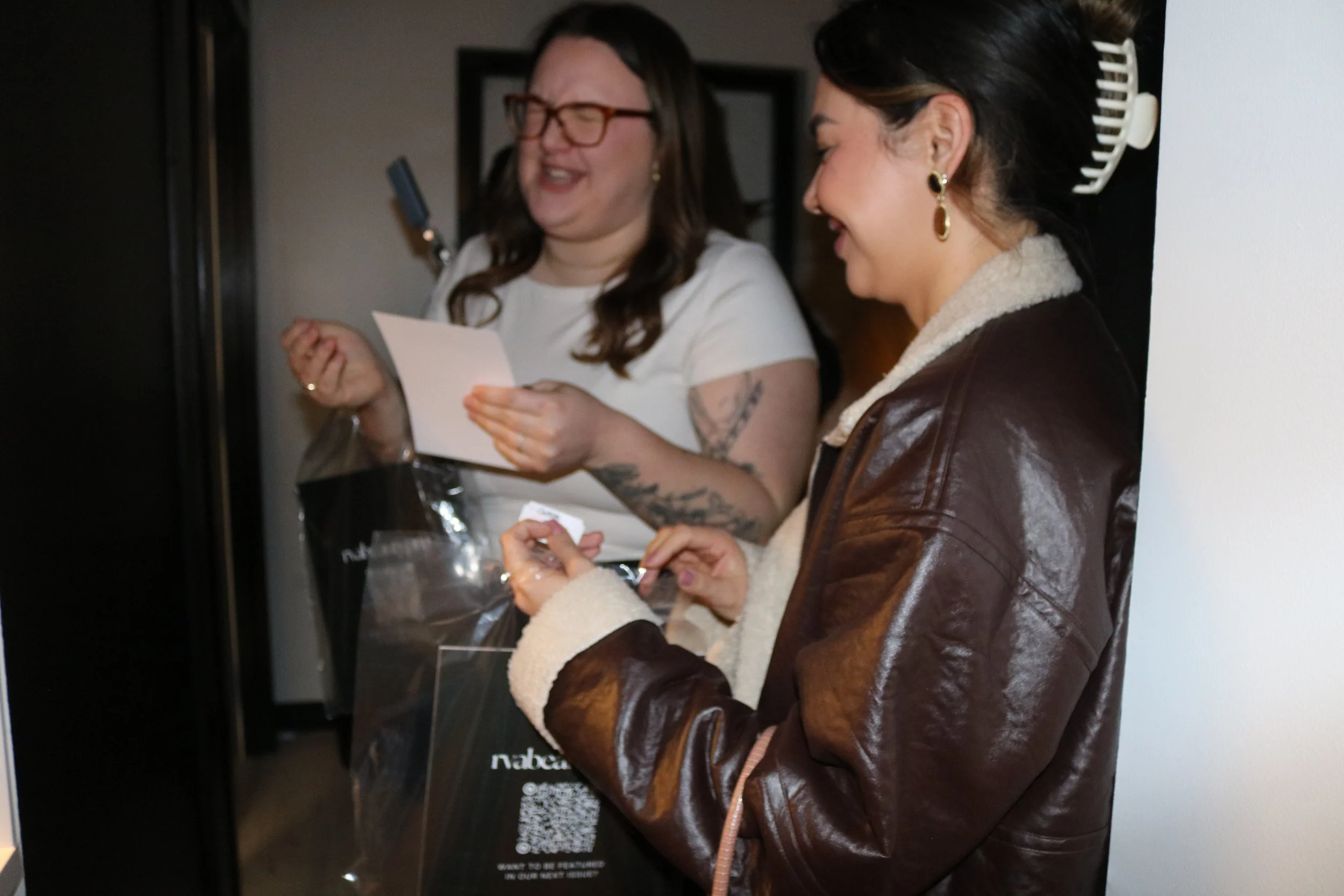 CHELSEA, OWNER OF BRAND GLOSS, SHOWN HOLDING A COPY OF THE RVABEAUTYPRO MAGAZINE.