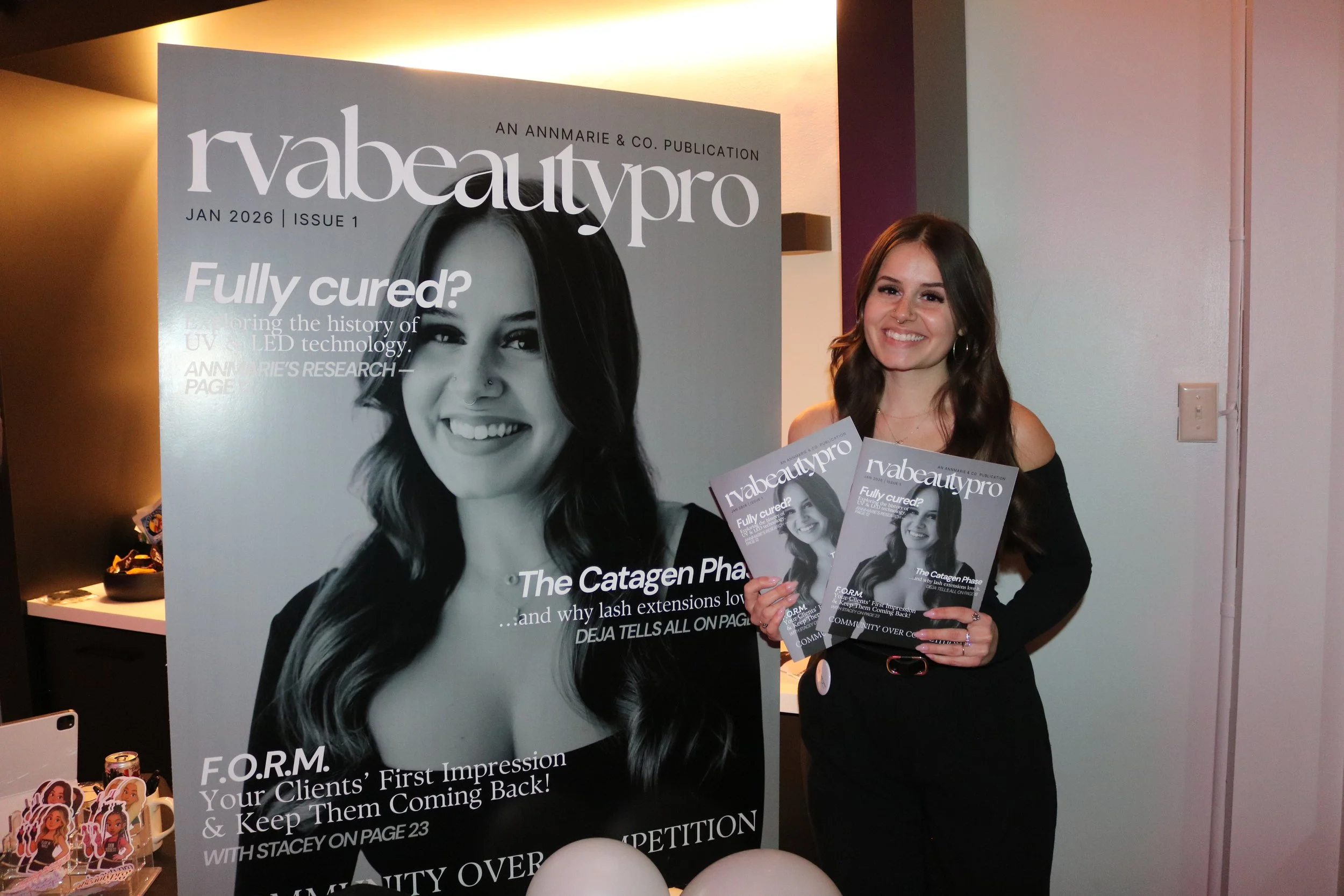 ANNMARIE VERDI WRIGHT PICTURED HOLDING A COPY OF RVABEAUTYPRO AT THE MAGAZINE LAUNCH EVENT IN RICHMOND, VIRGINIA.