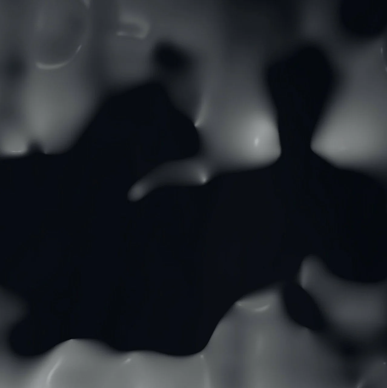 Dark liquid spilled on a white surface.