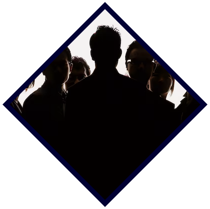 Silhouettes of five people with one person prominently in front, all facing forward, against a bright background.