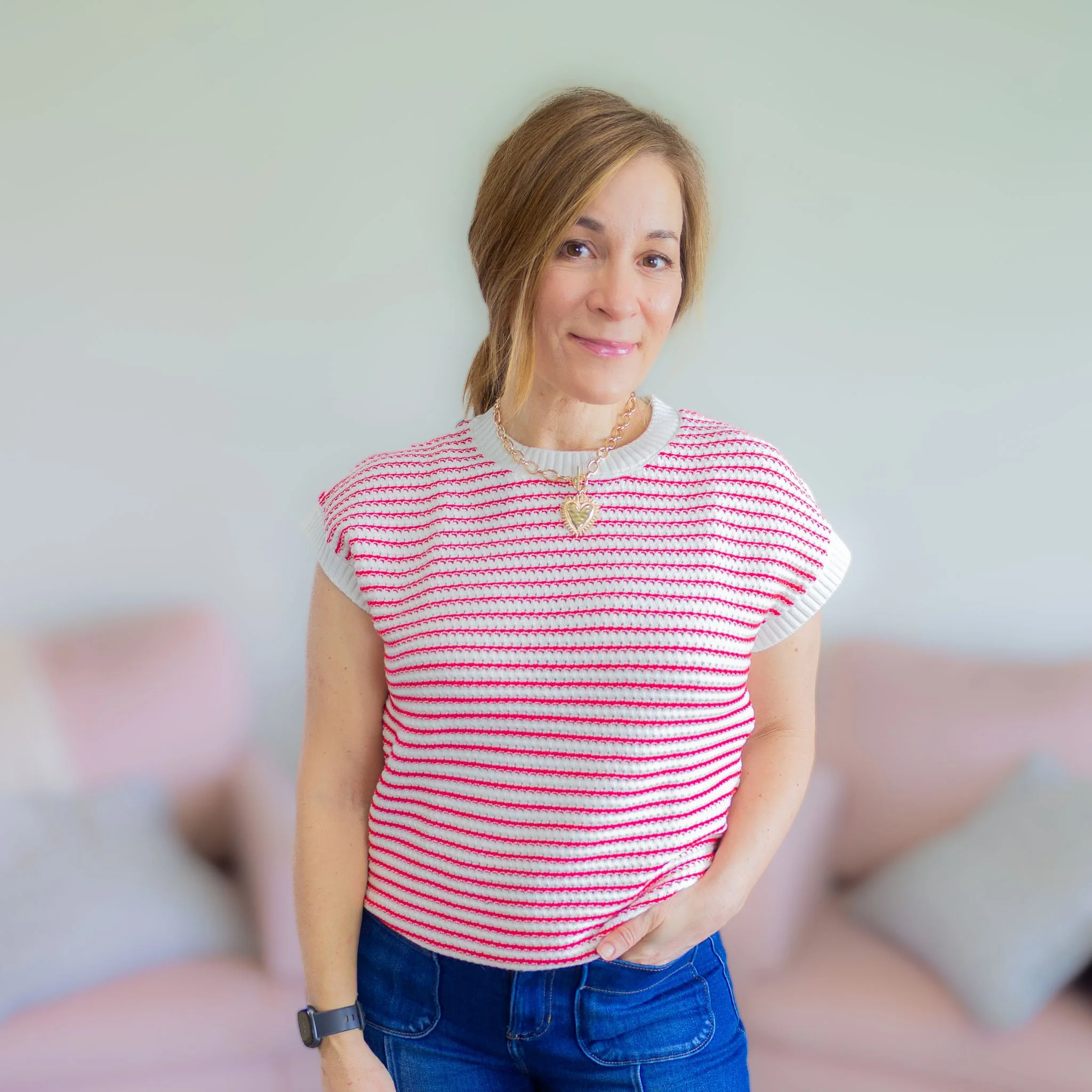 woman wearing red and white stripe top with short sleeves.