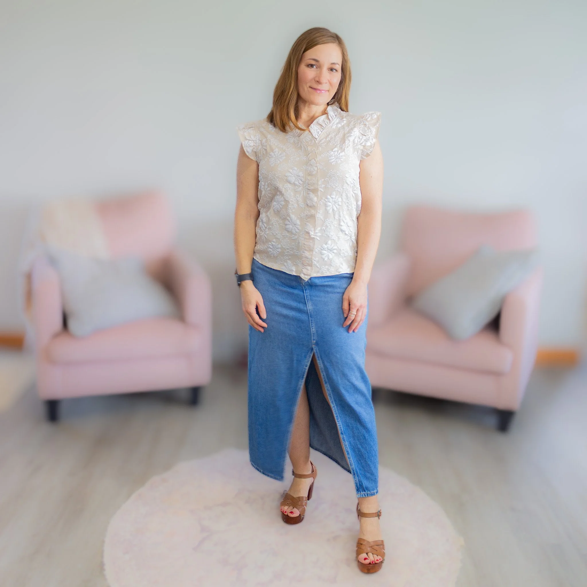 woman wear white and tan floral jacquard top with long denim skirt.