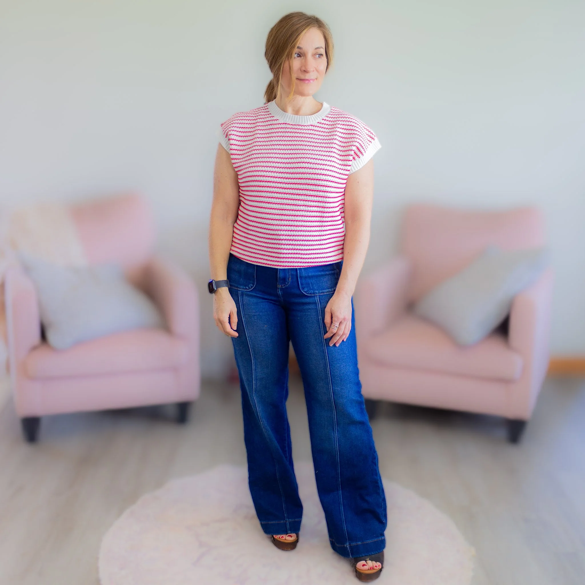 red and white striped sweater top being worn by woman in jeans.