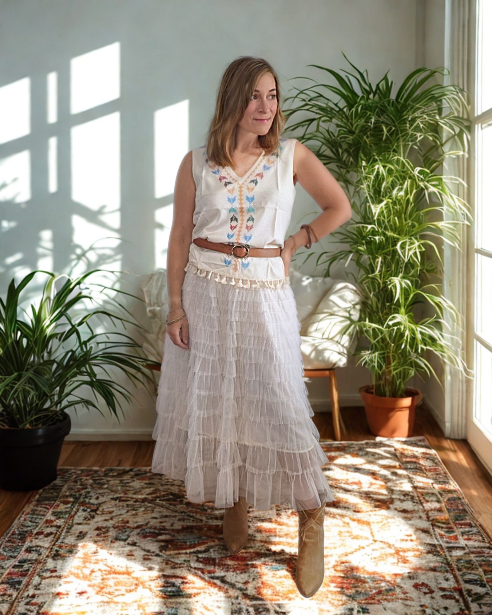Woman wear sleeveless Western inspired top with belt and mesh skirt.