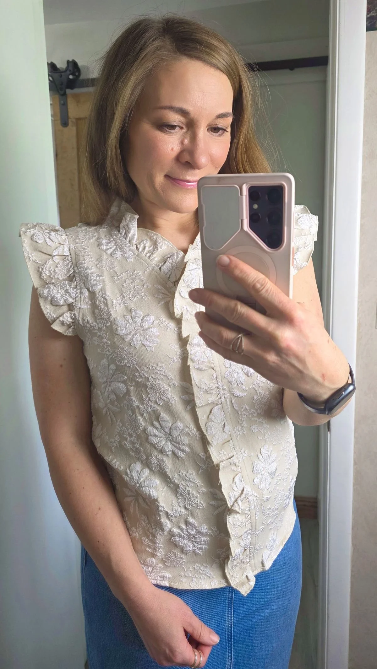 Mirror selfie of primarily tan and white jacquard sleeveless top.