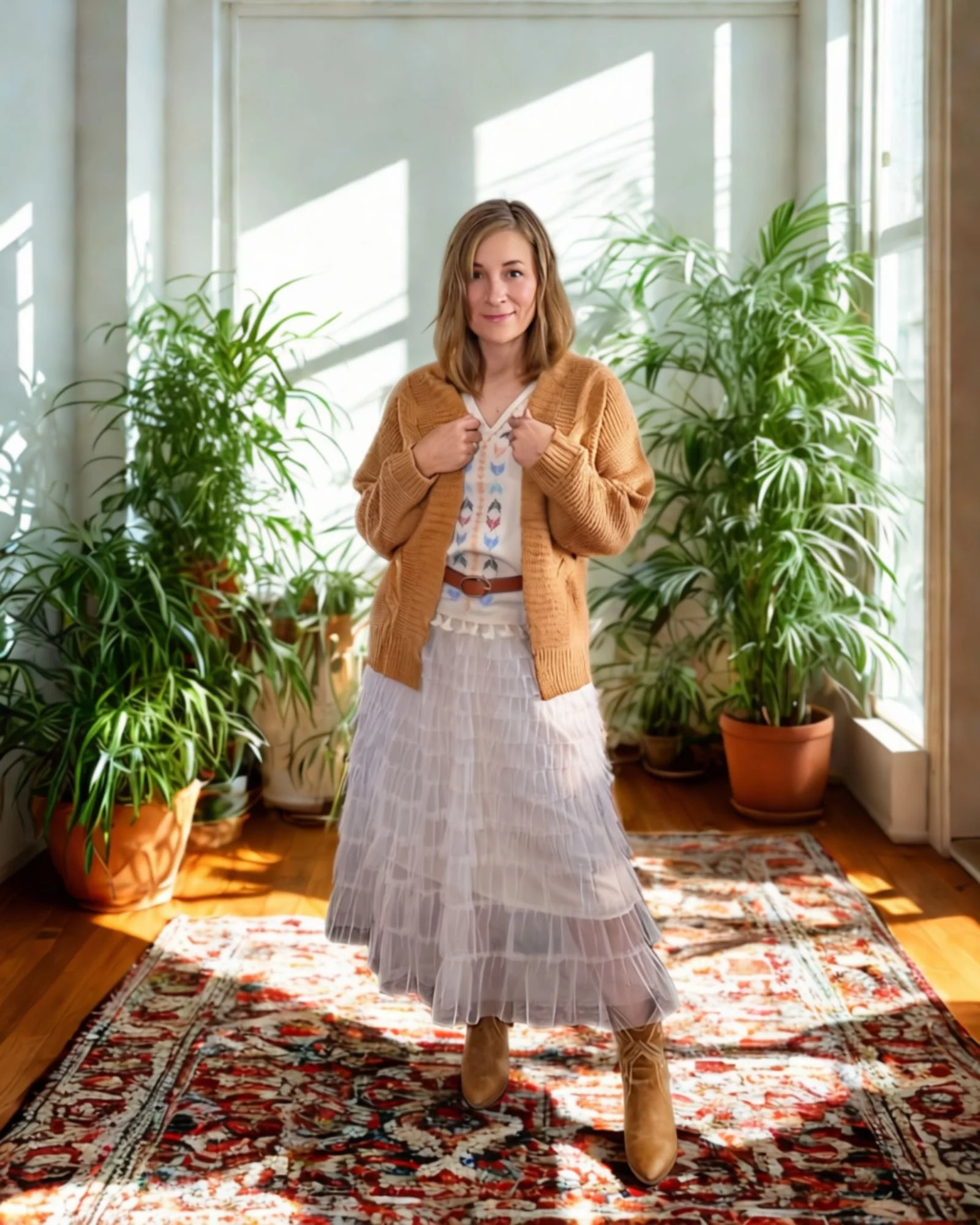 Woman wearing western style top under a khaki cardigan and cream mesh skirt.