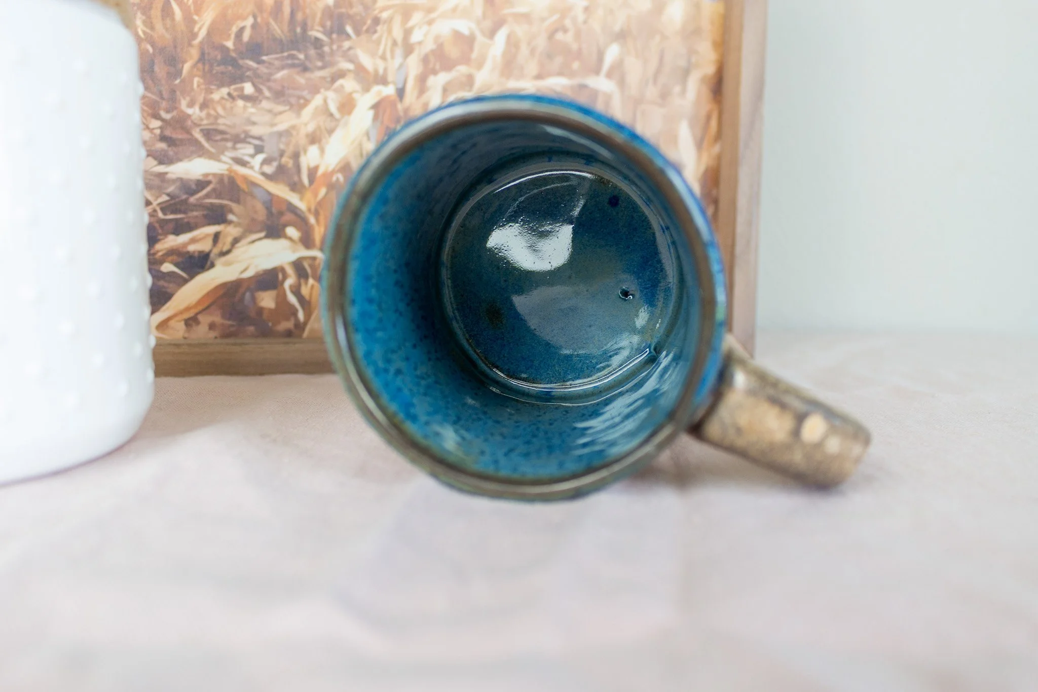 wheat mug on it's side showing dark blue interior.