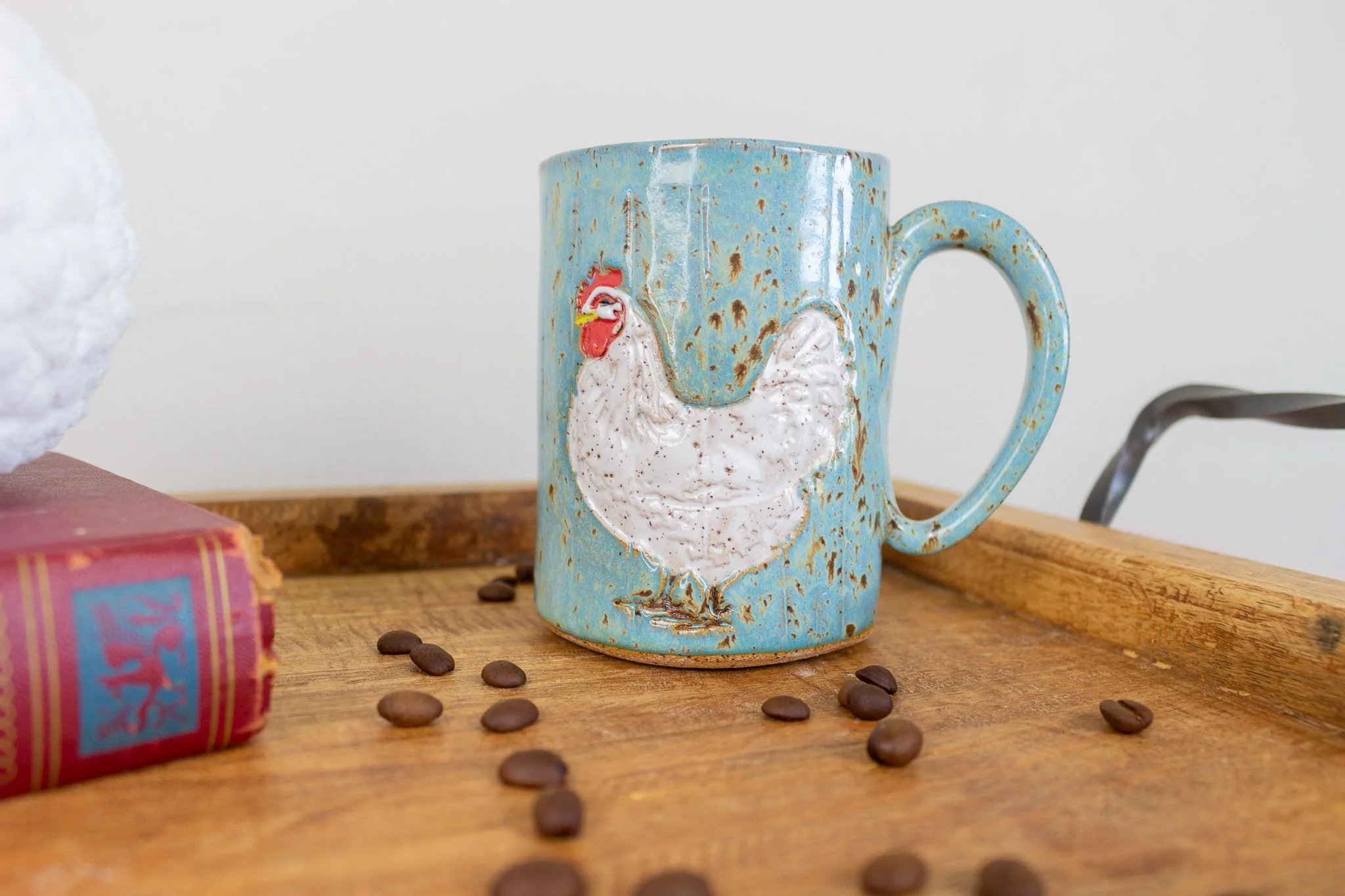 handmade rooster mug showing white rooster on turquoise background.