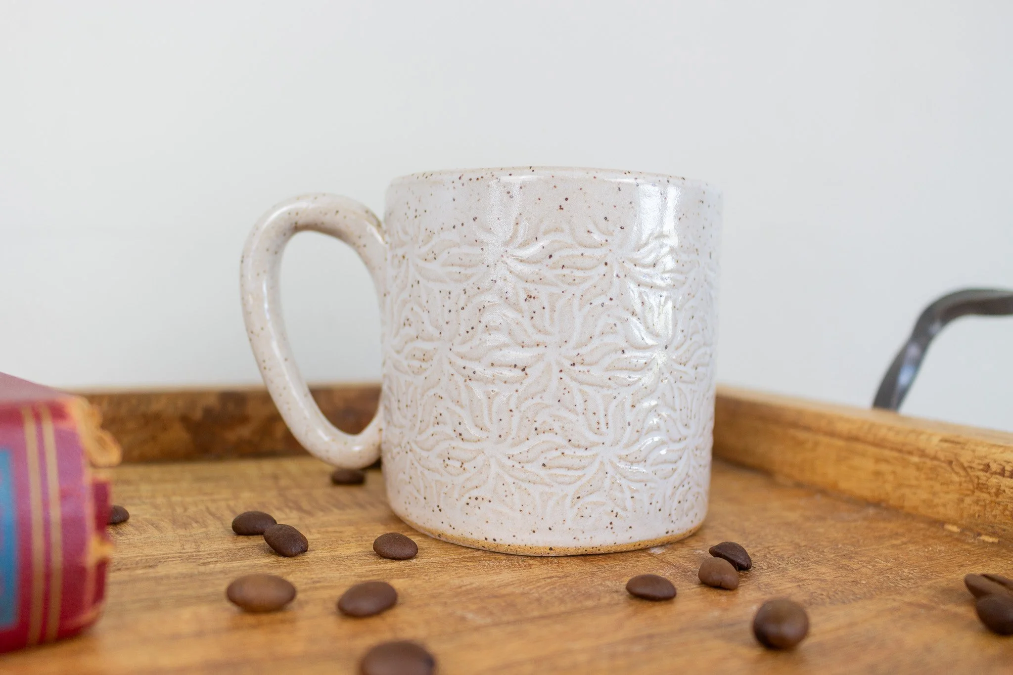 back of black cat mug which is cream with kaleidoscope type design