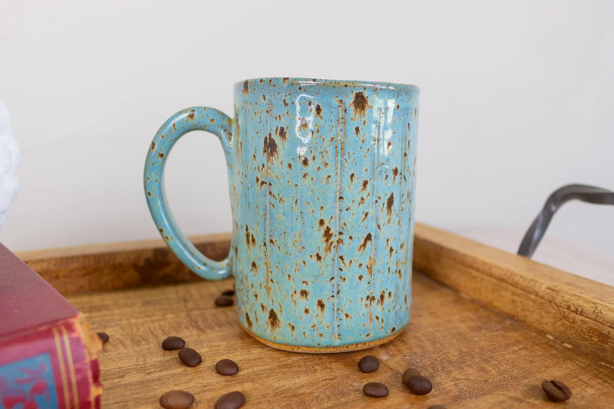 back of rooster mug showing painted turquoise and speckled side.