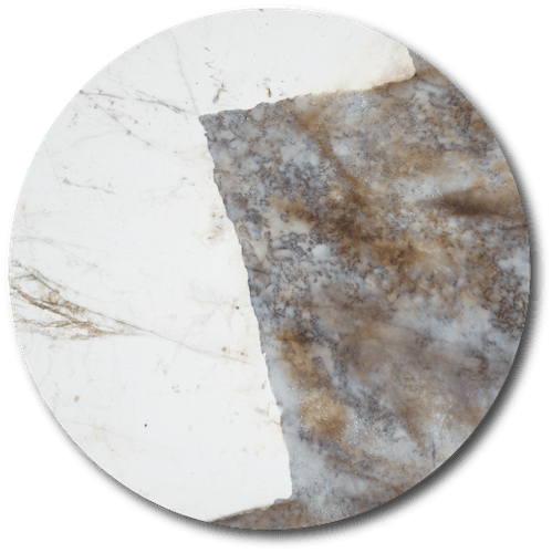 Close-up of a circular marble surface with white and brownish-gray patches.