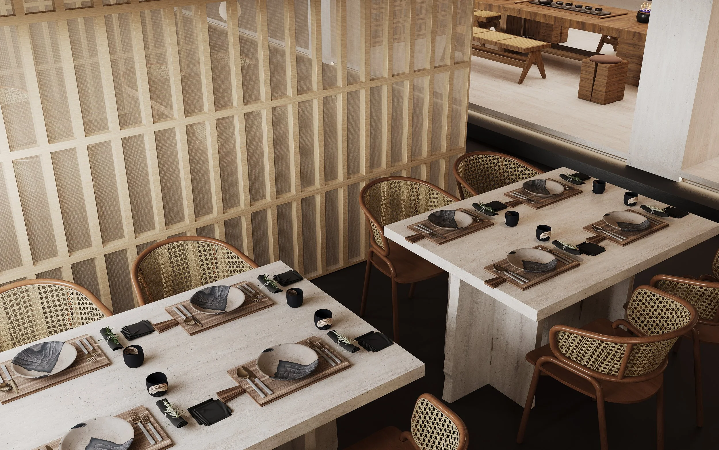 A dining area with a beige stone table set for six, featuring black bowls, black napkins, and wooden serving plates. Six elegant chairs with woven backs surround the table. The room has a neutral color palette with light wood accents, and a decorative wooden partition separates it from an adjacent space that contains a long wooden table with benches and stools.