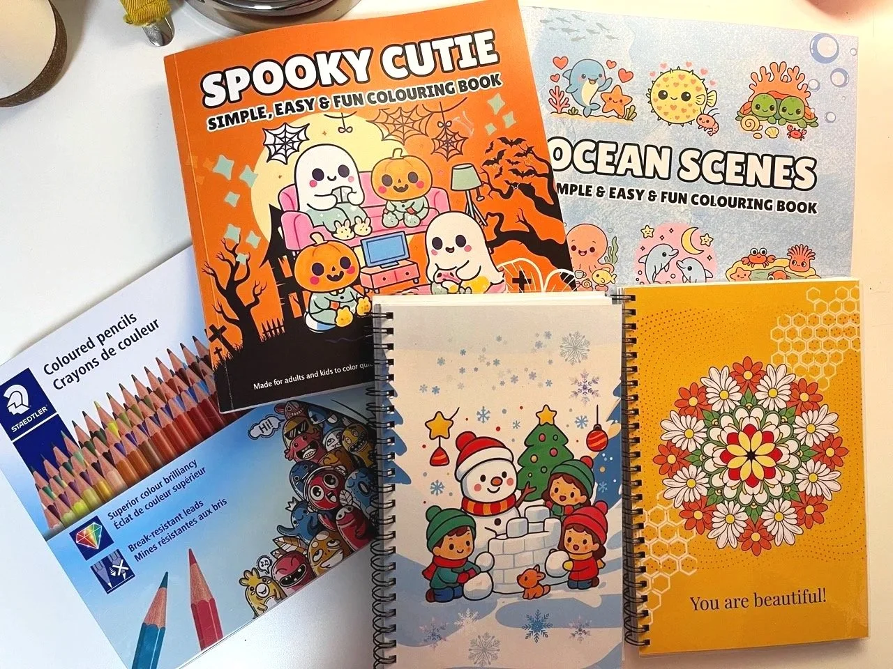 2 colouring books + 2 notesbooks + 1 Stadtlers 72 coloured pencils