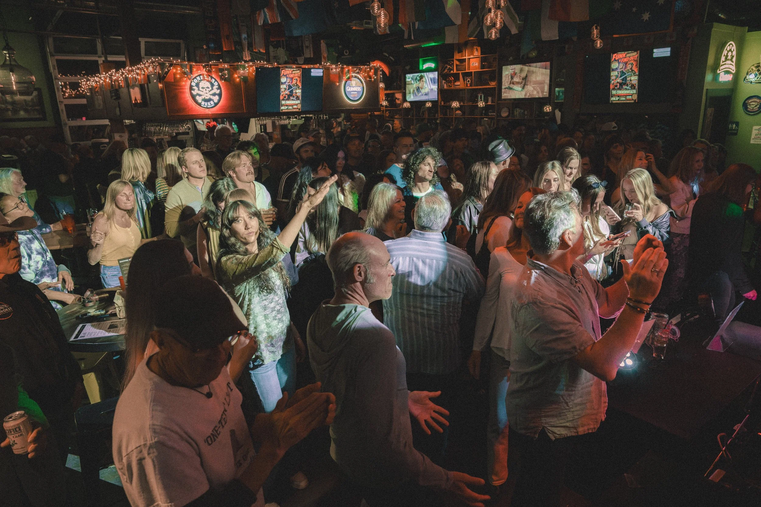 Audience members dancing during a Funk Around & Find Out live show.
