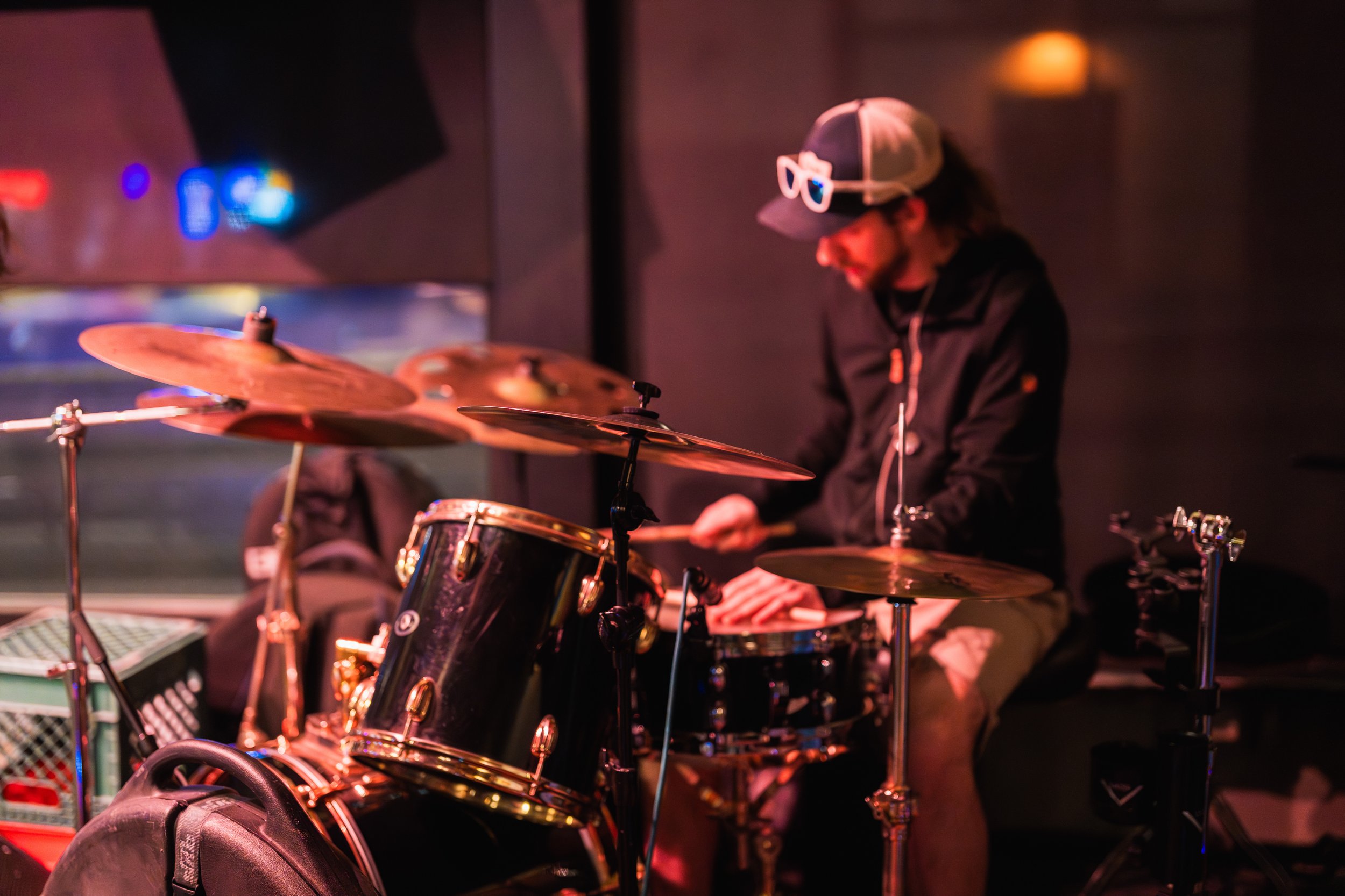 Andy Gentile playing drums from the side of the stage.