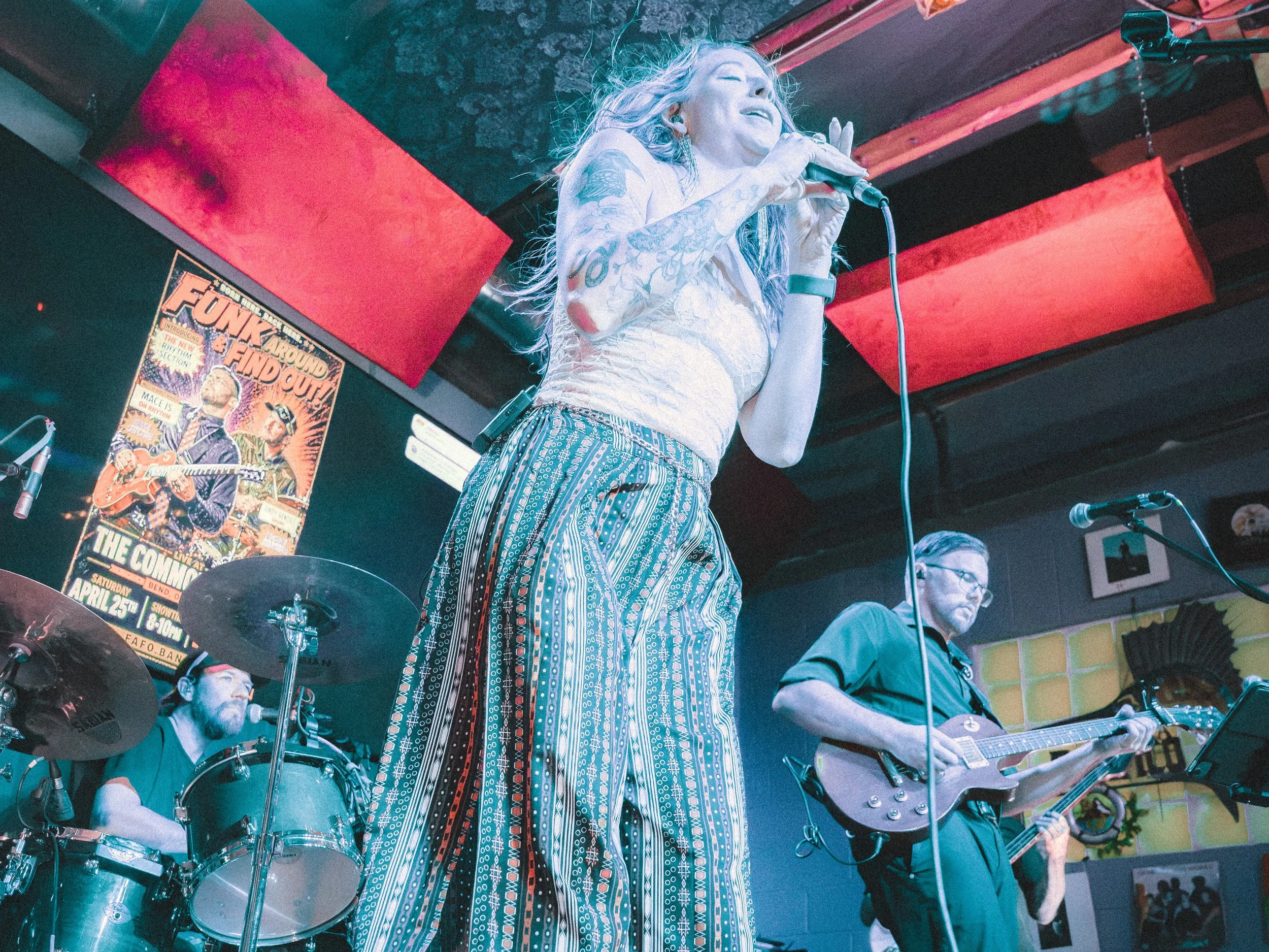 Liz Bauer performing with Funk Around & Find Out behind her.