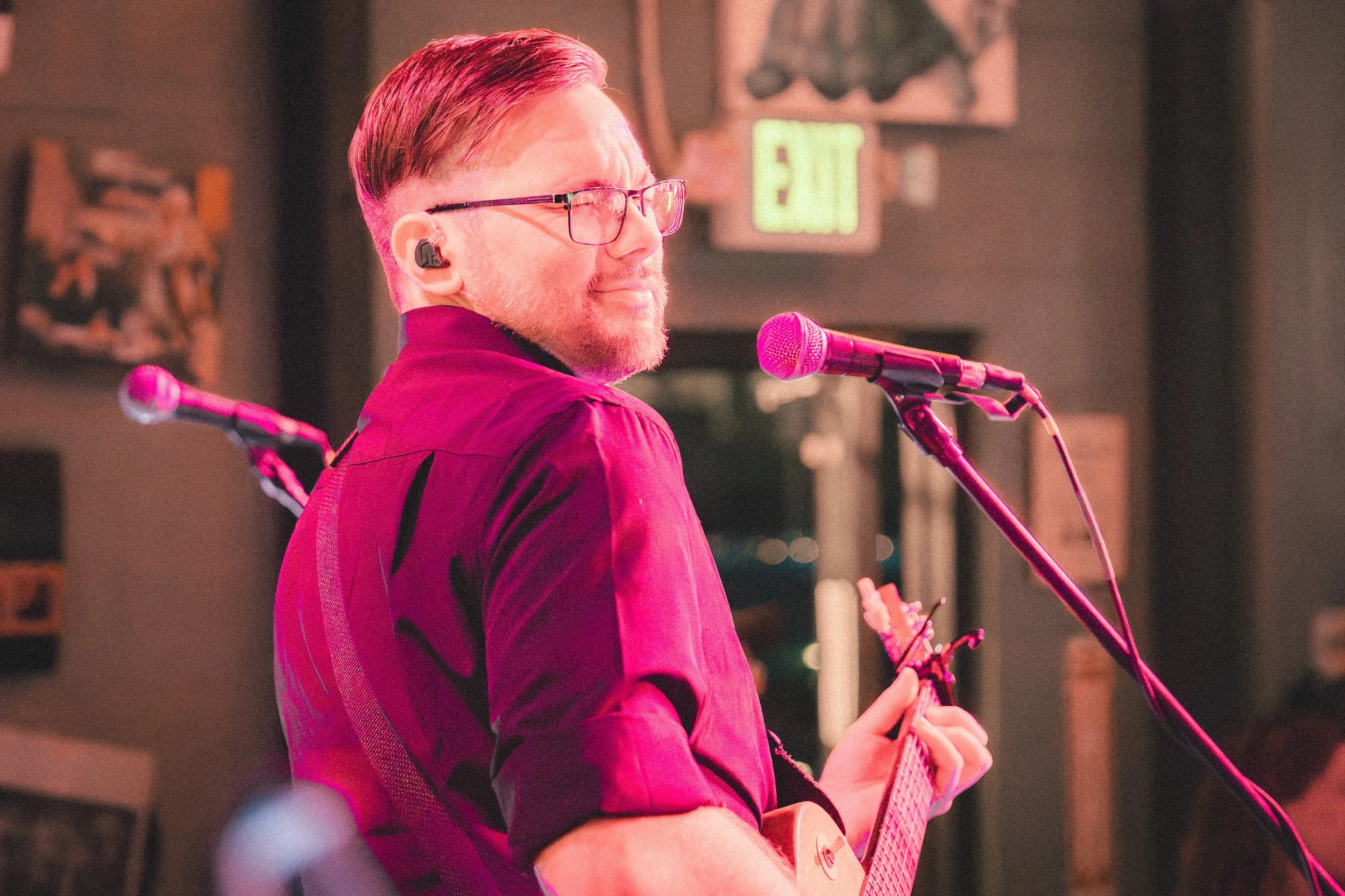 Mason James playing rhythm guitar during a Funk Around & Find Out performance.