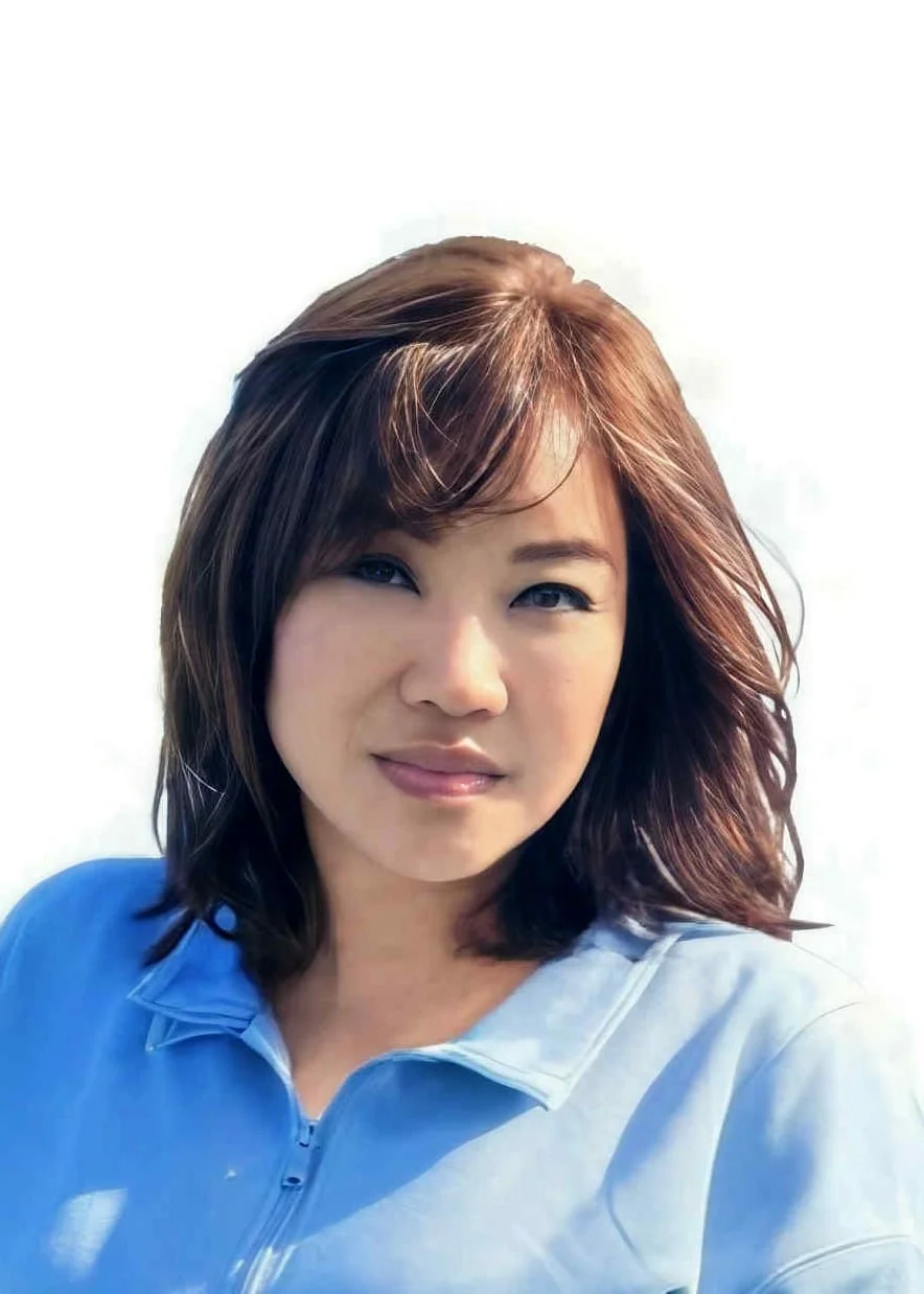 A woman with medium-length, layered brown hair, wearing a light blue zip-up top, smiling slightly against a plain, light background.